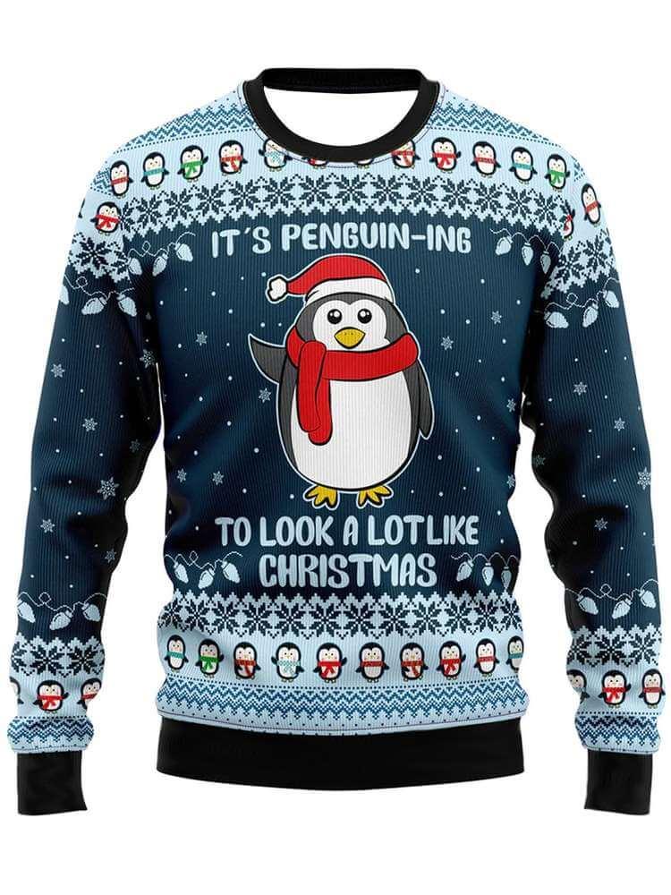 Cute Christmas penguin sweater with pom pom, festive design, snowflakes, and holiday text