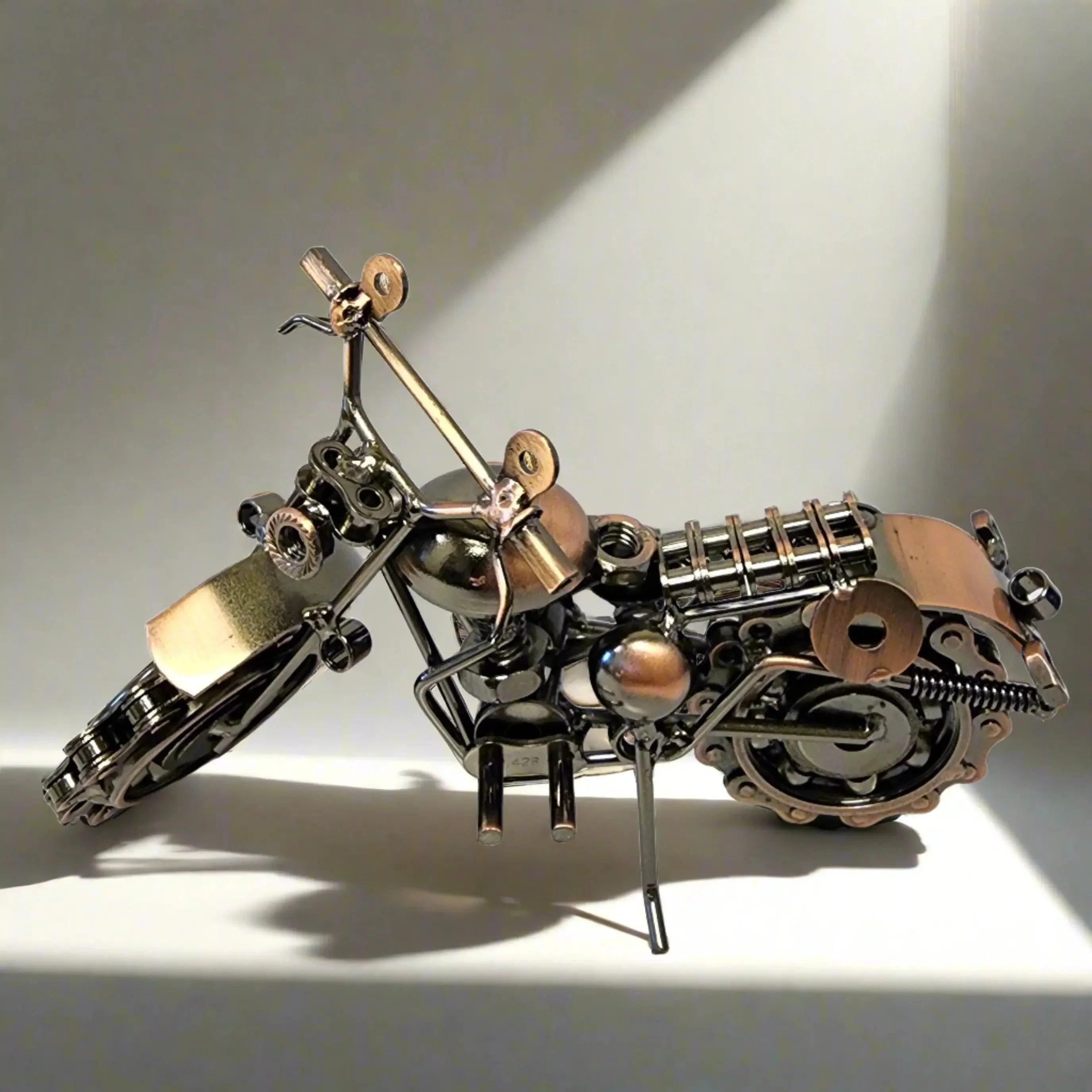 Metal motorcycle model made from nuts and bolts on a white background, home decor gift.