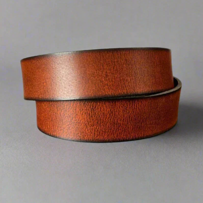 Brown leather belt with matte finish on gray background, classic men's accessory