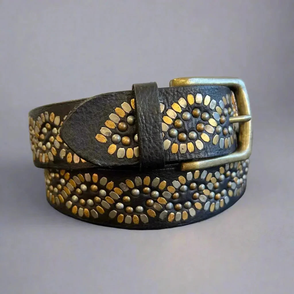 Women's full-grain leather belt with gold studs and brass buckle on a plain background