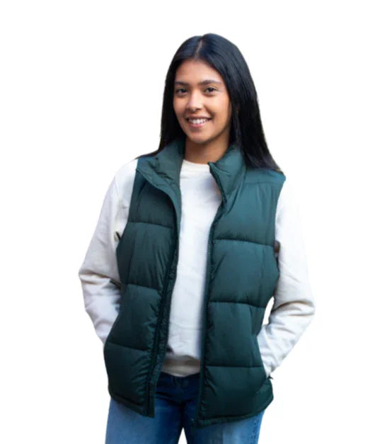 Woman wearing a green puffer vest over a white sweatshirt and blue jeans, front view