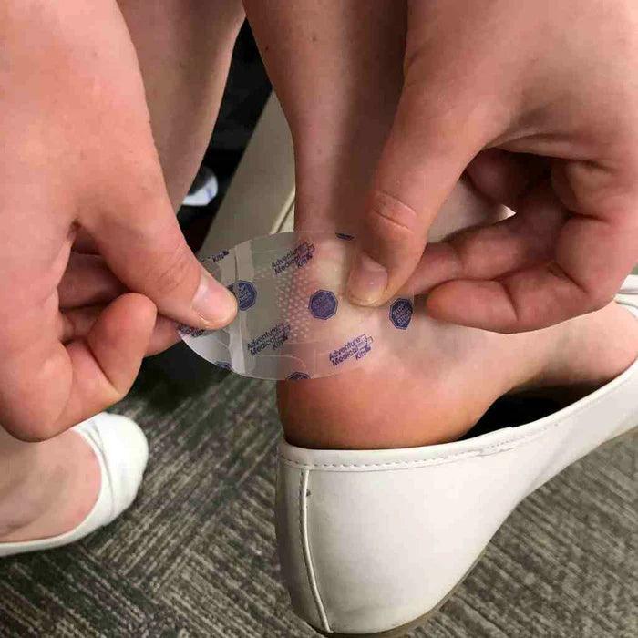 Applying GlacierGel blister dressing to heel for foot blister relief