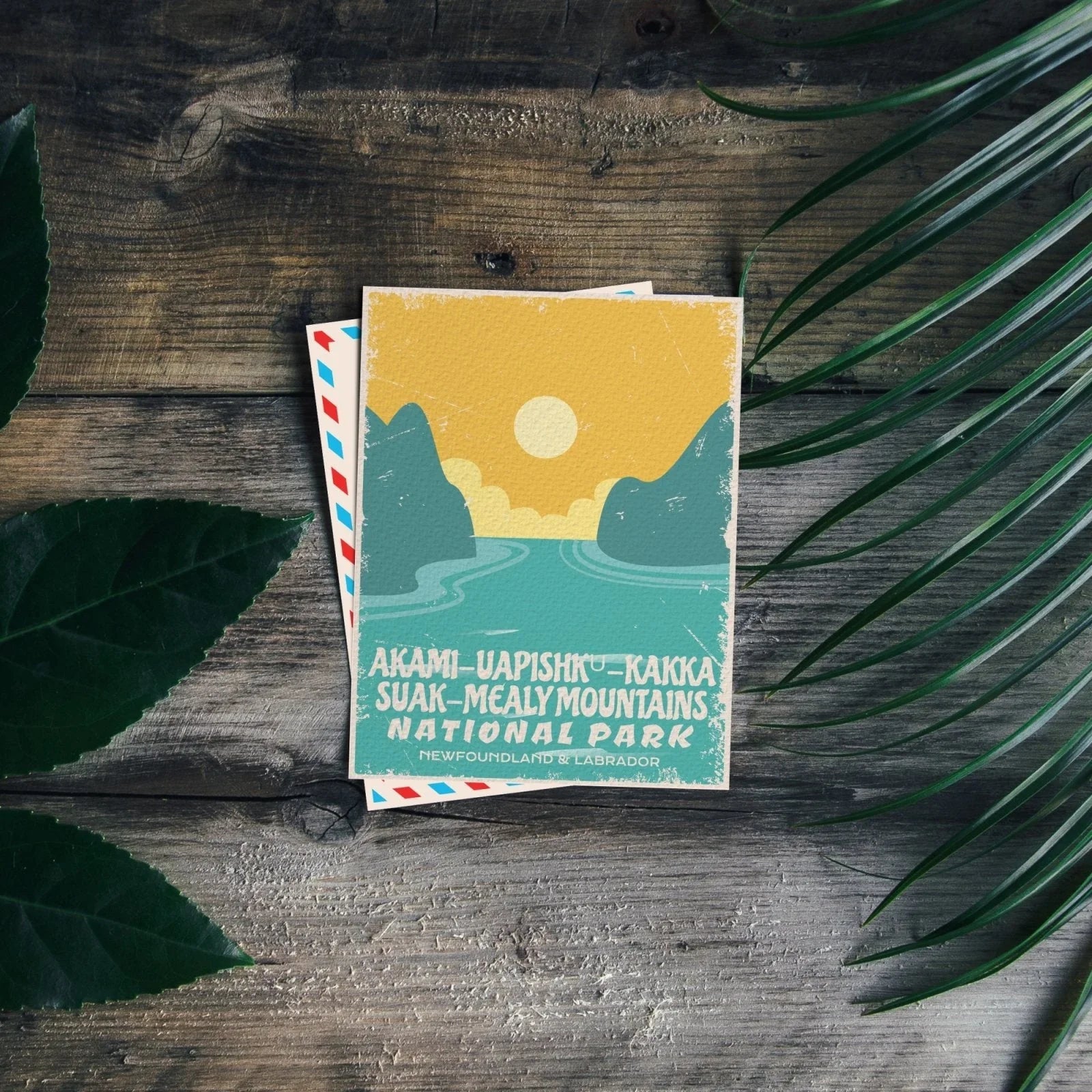 Akami-Uapishku-KakKasuak-Mealy Mountains National Park postcard on wood with leaves