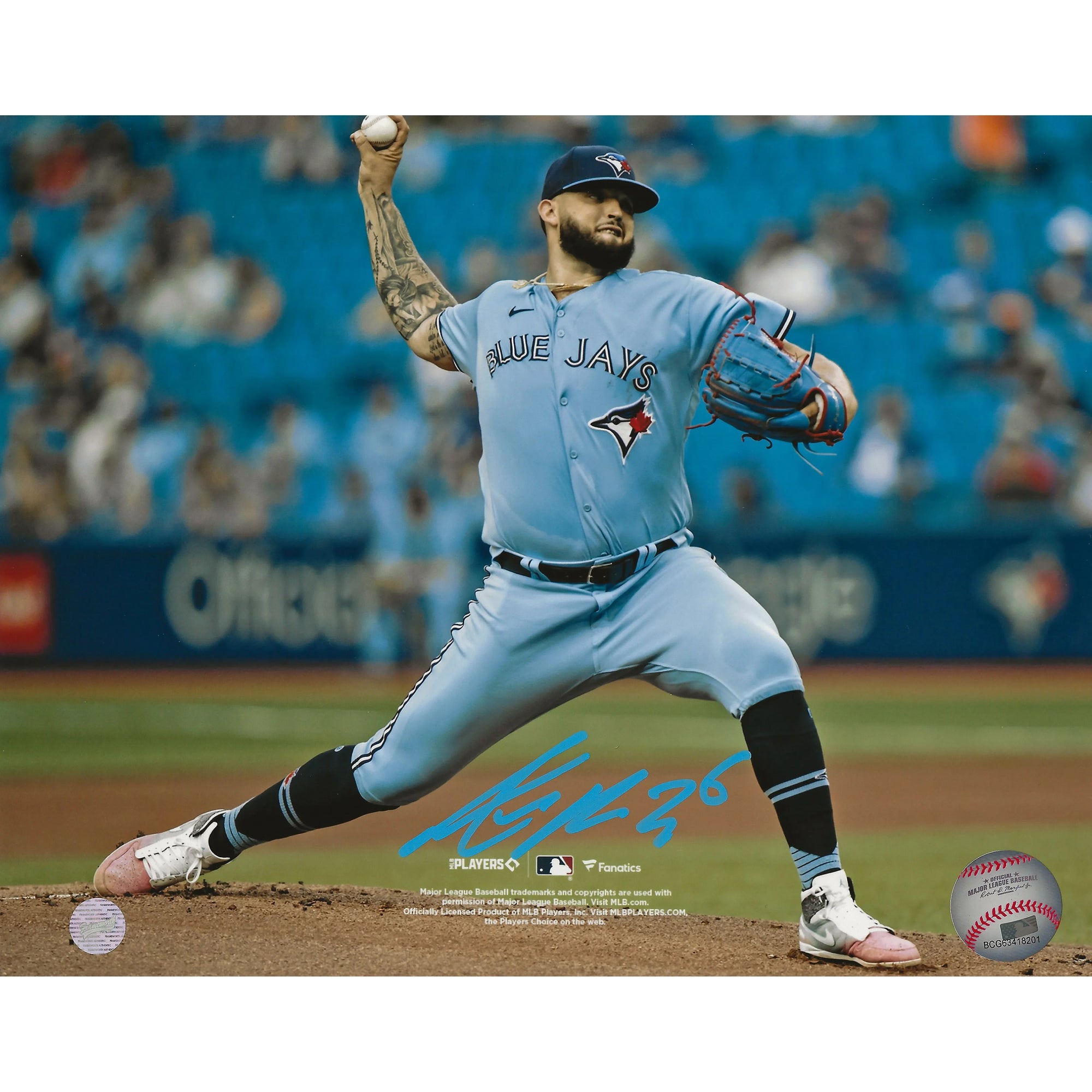 Toronto Blue Jays pitcher in blue uniform on mound mid-pitch, signed photo, baseball stadium