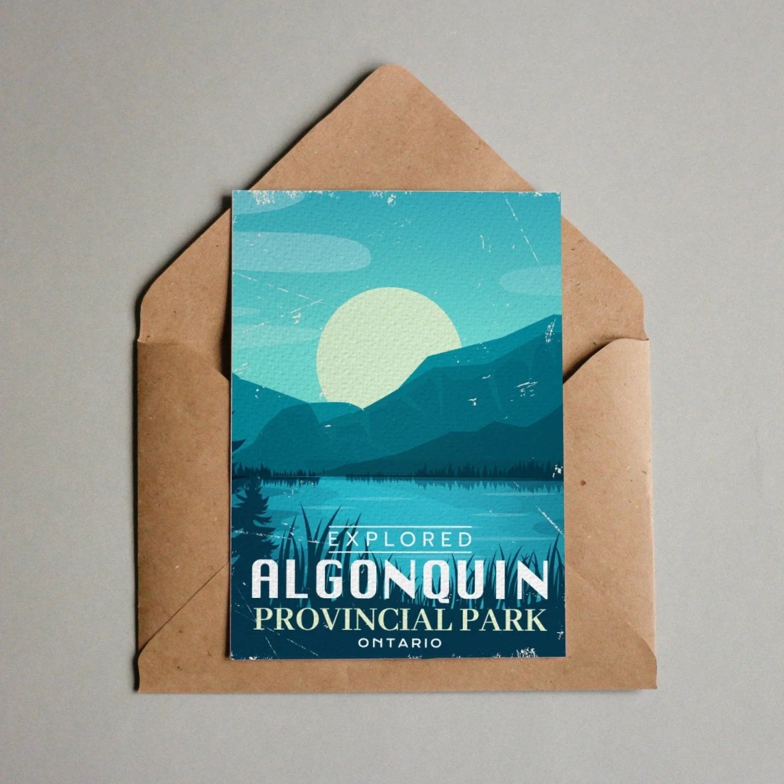 Algonquin Provincial Park Ontario postcard with lake, mountains, and brown envelope