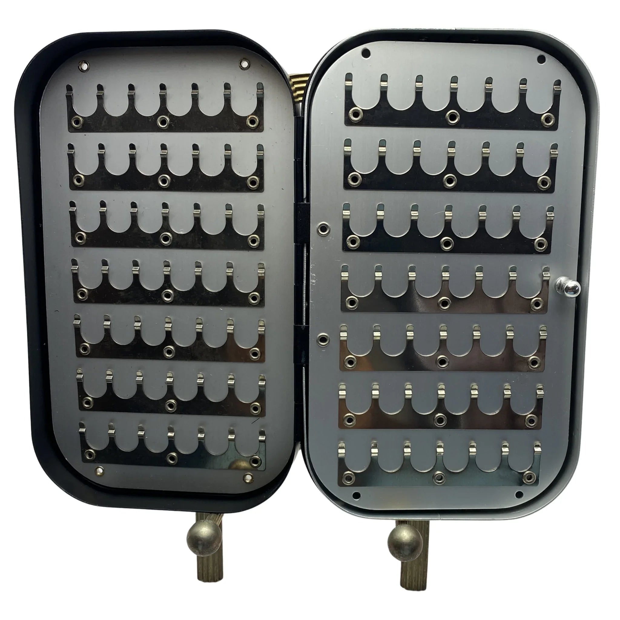 Open black aluminum fly box with slotted metal fly holders, designed for fly fishing storage.