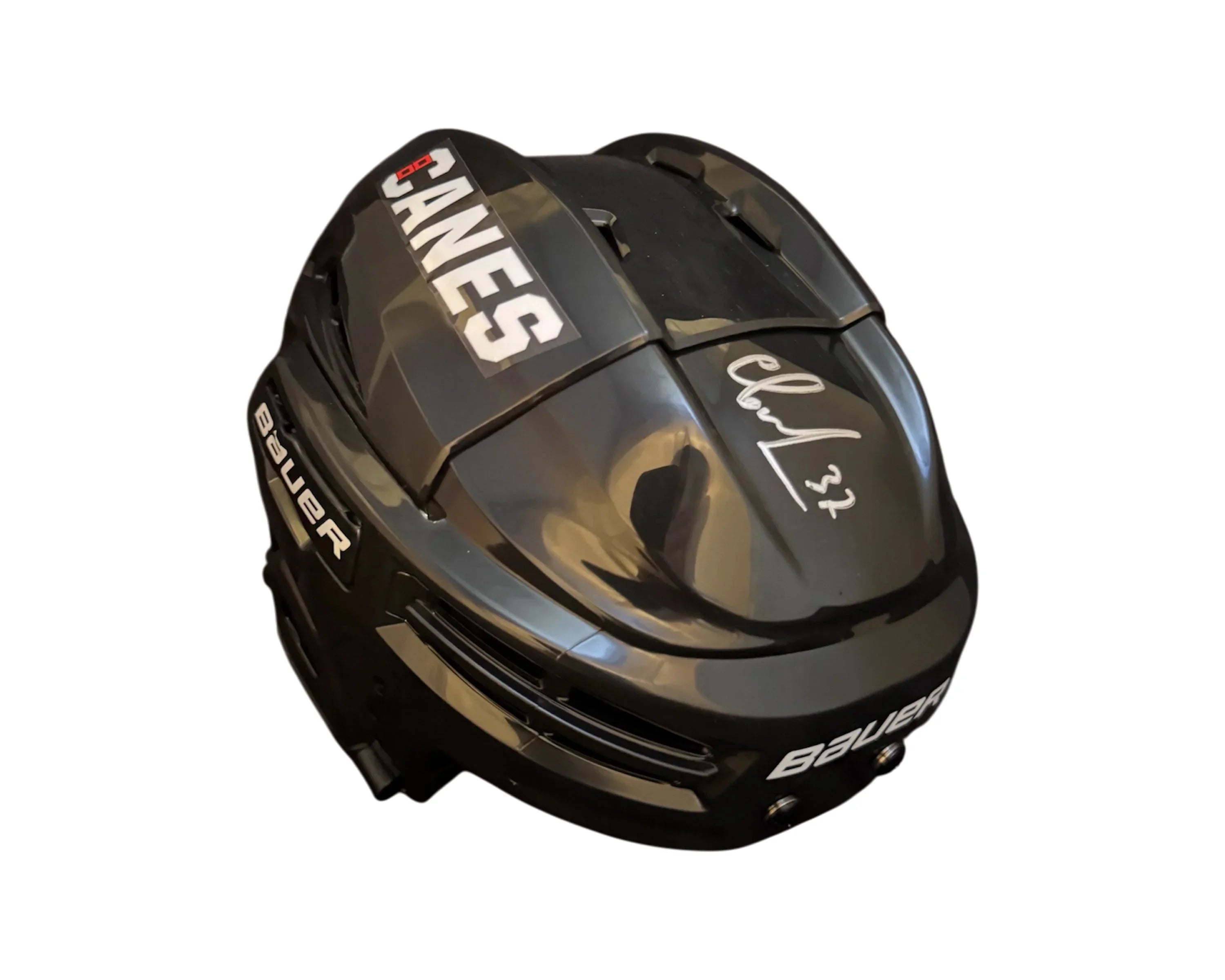 Black Bauer hockey helmet with CANES label and silver autograph on top