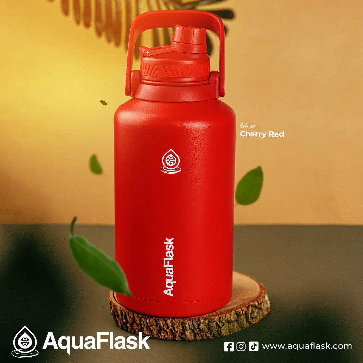 AquaFlask 64 oz Cherry Red water bottle with handle, displayed on wooden base, product branding visible.
