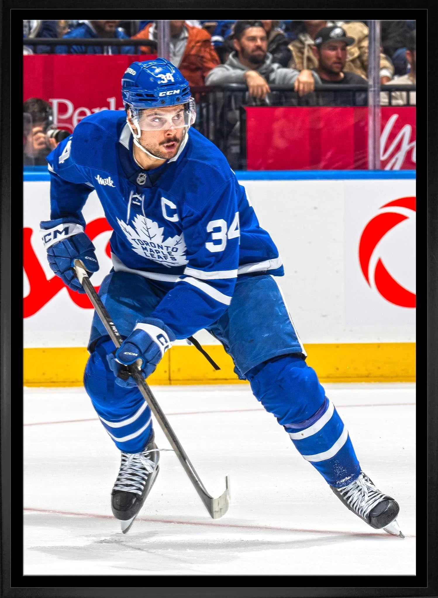 Toronto Maple Leafs hockey player in blue jersey skating on ice during game