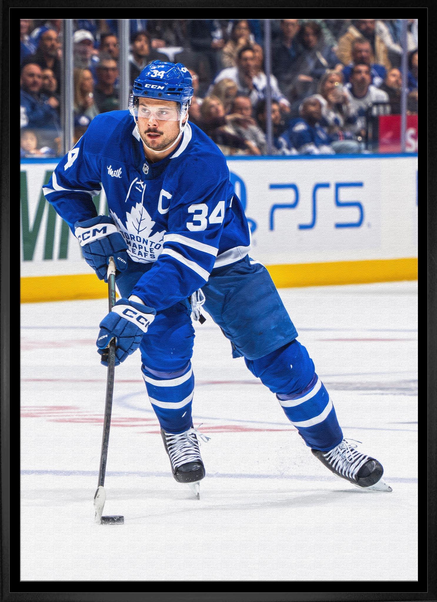 Toronto Maple Leafs hockey player in blue jersey skating on ice during game