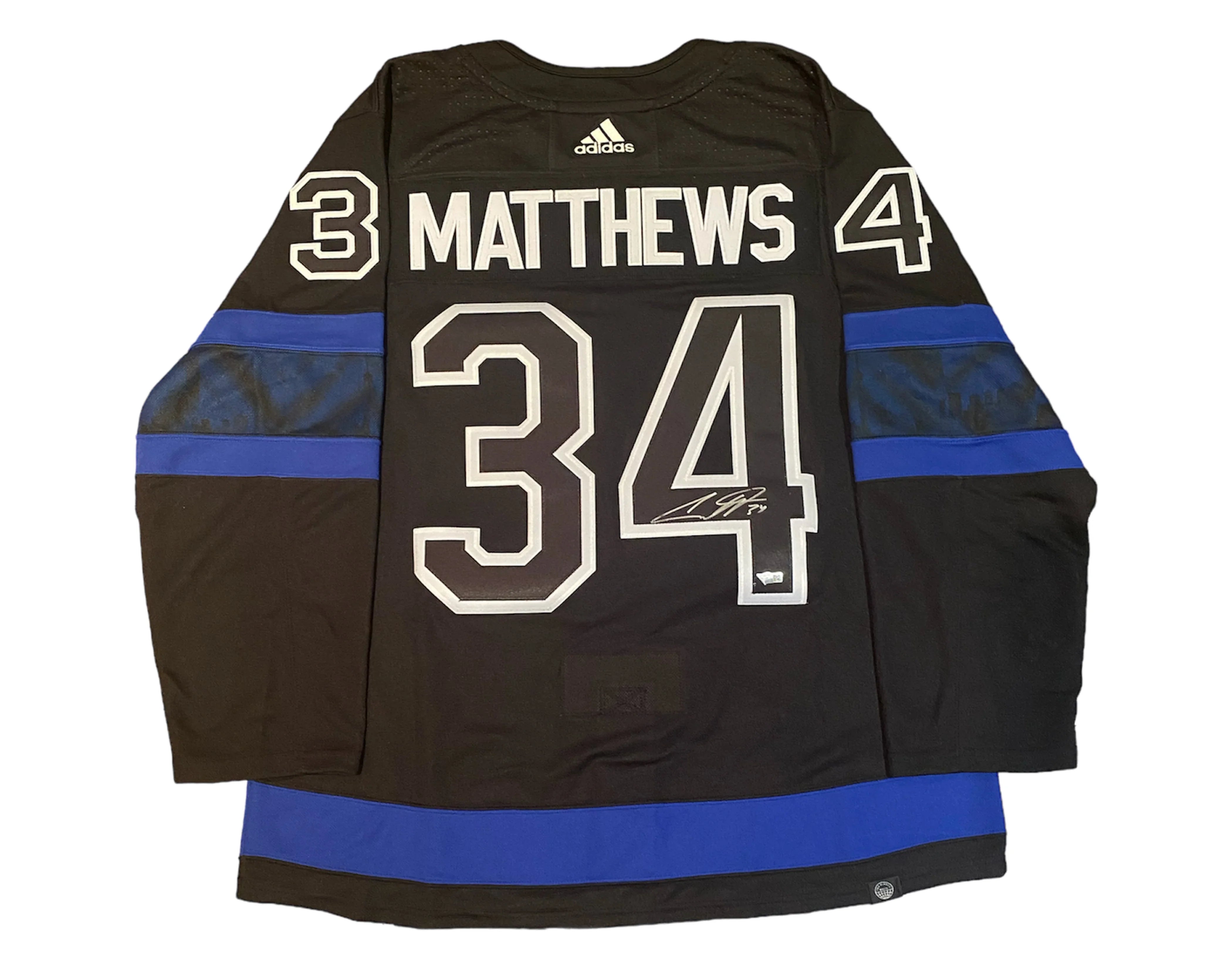 Black Adidas hockey jersey with Matthews 34, blue stripes, and visible signature