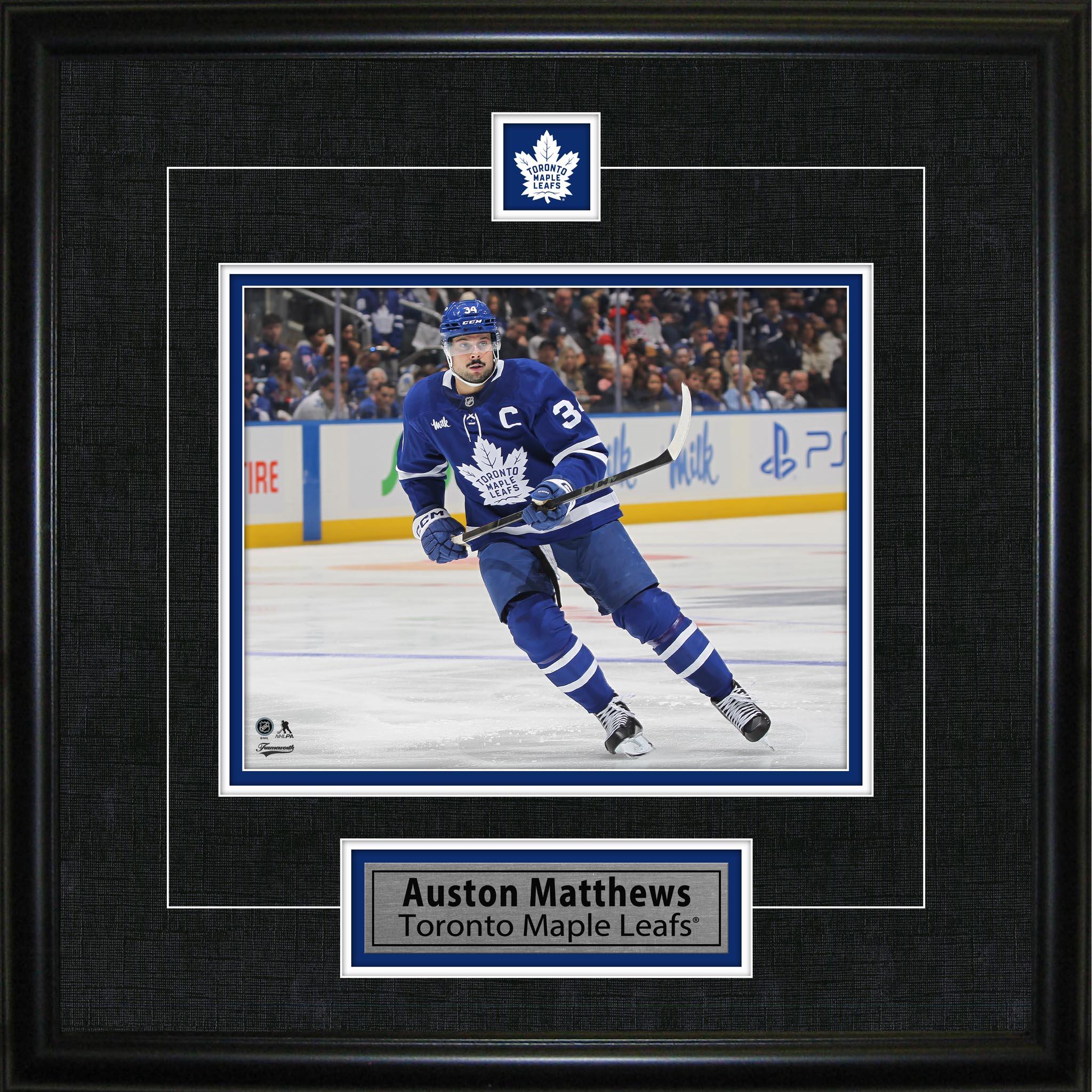 Framed photo of hockey player in Toronto Maple Leafs uniform skating on ice rink