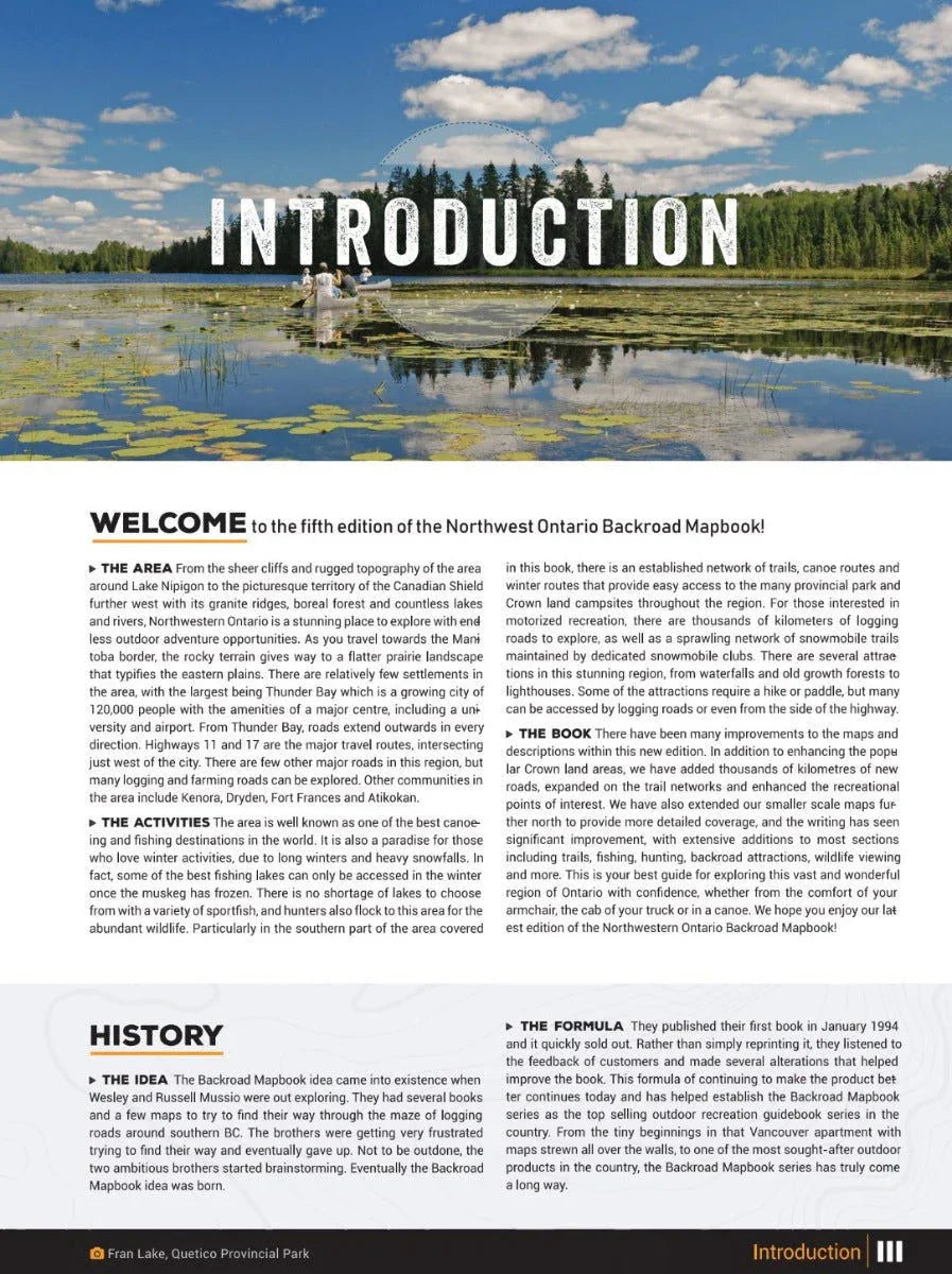 Canoe on tranquil lake with lily pads, forest, and blue sky, Northwestern Ontario Backroad Mapbook cover