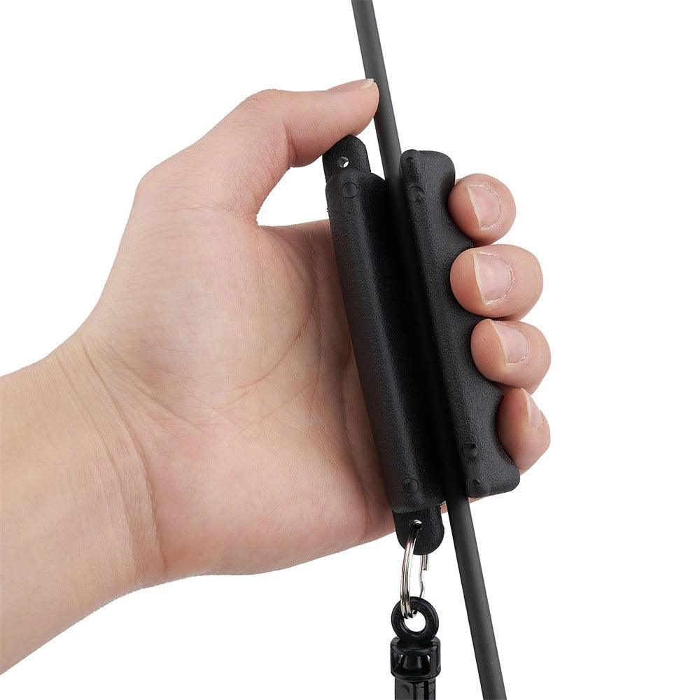 Hand holding black archery arrow puller tool on an arrow shaft
