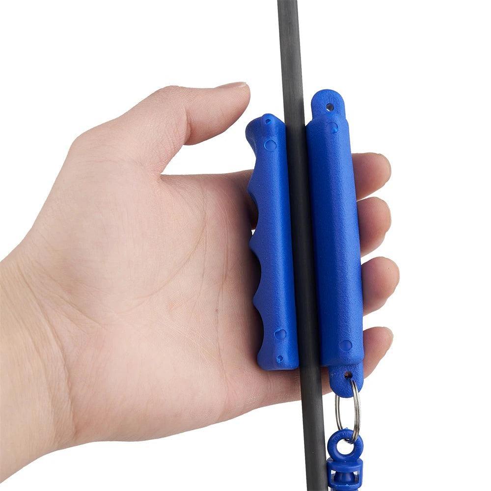 Hand holding blue archery arrow puller tool gripping a black arrow shaft