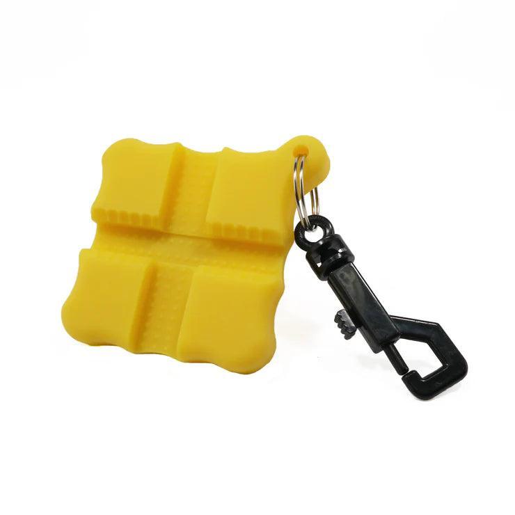 Yellow silicone archery arrow puller with black carabiner clip on white background