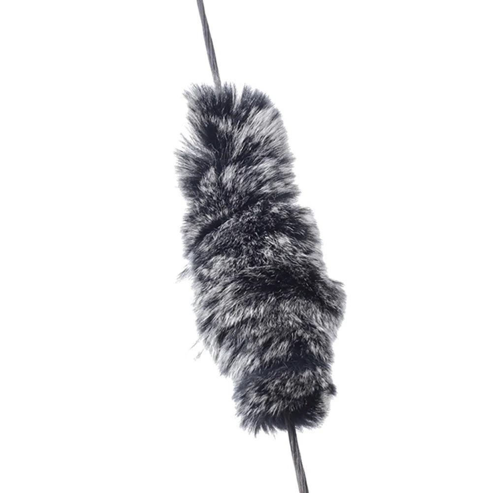 Furry black and grey archery string silencer on recurve bow string, isolated on white