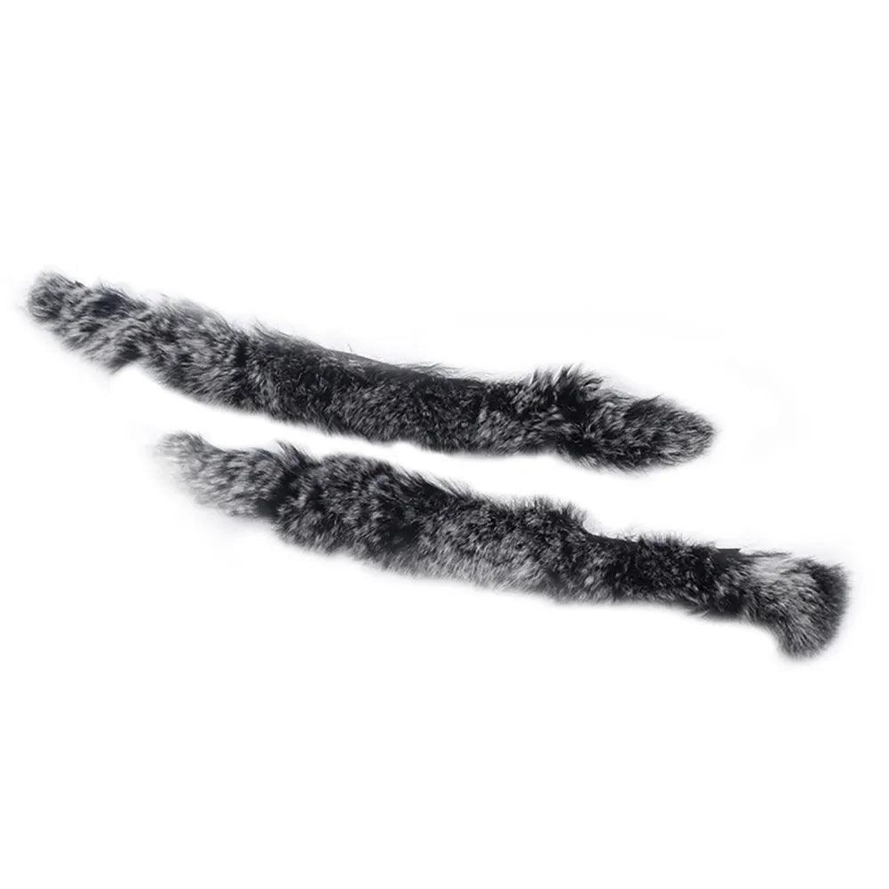 Pair of black and grey archery string silencers for recurve bows on white background