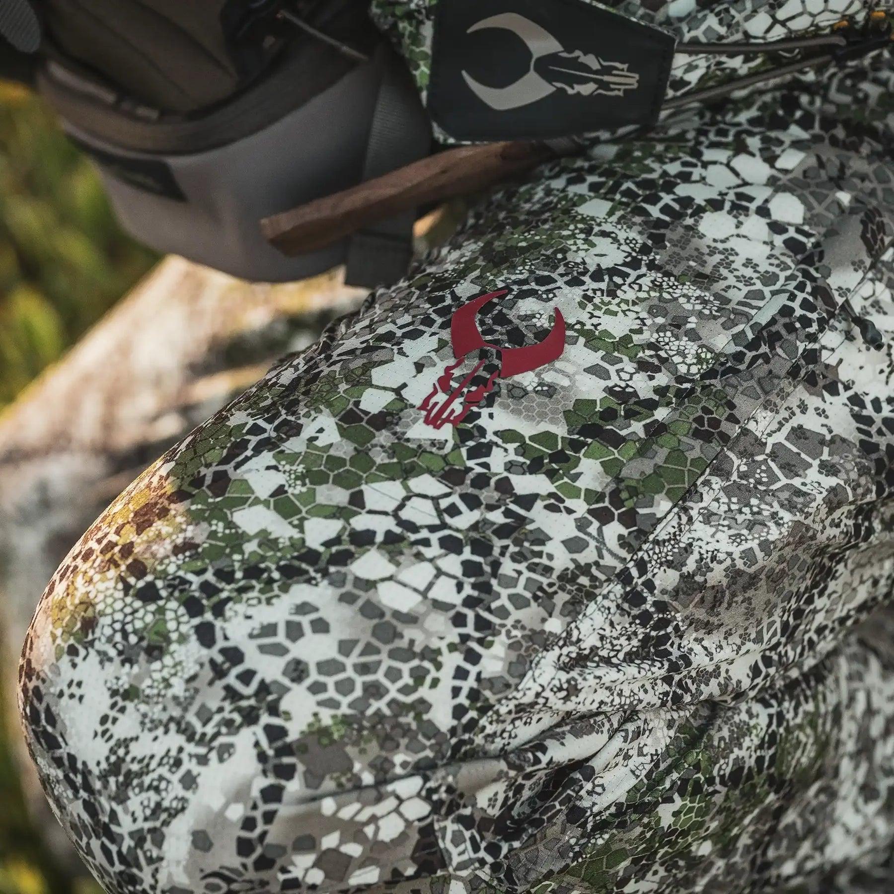 Badlands Andaire camo pants with red skull logo, outdoor sports apparel close-up shot