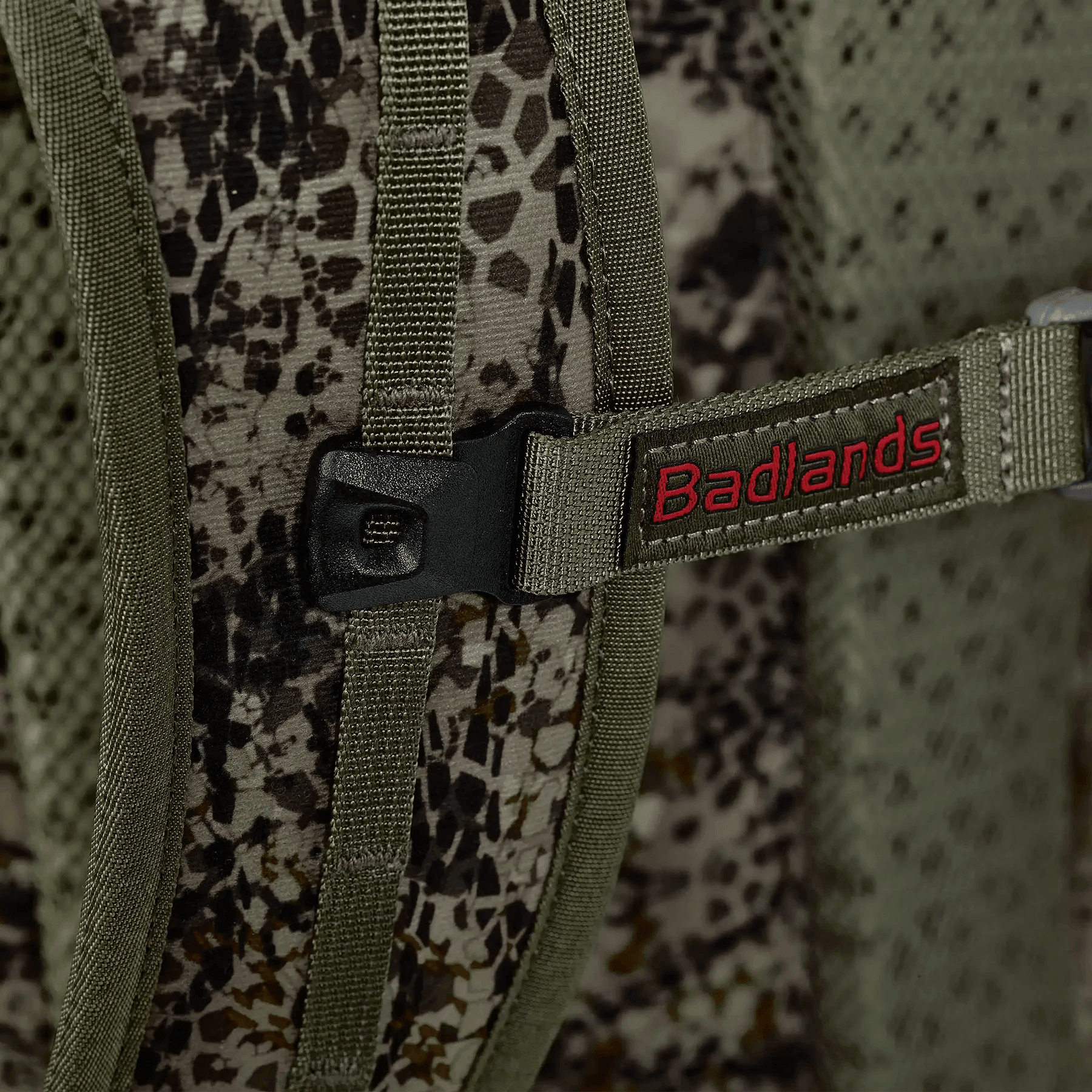 Close-up of Badlands ATX-25 frame pack camouflage fabric and secure strap buckle