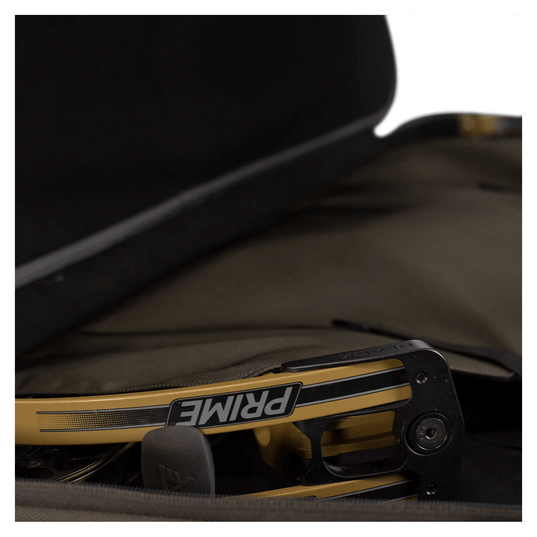 Prime bow riser in a padded black and tan archery case