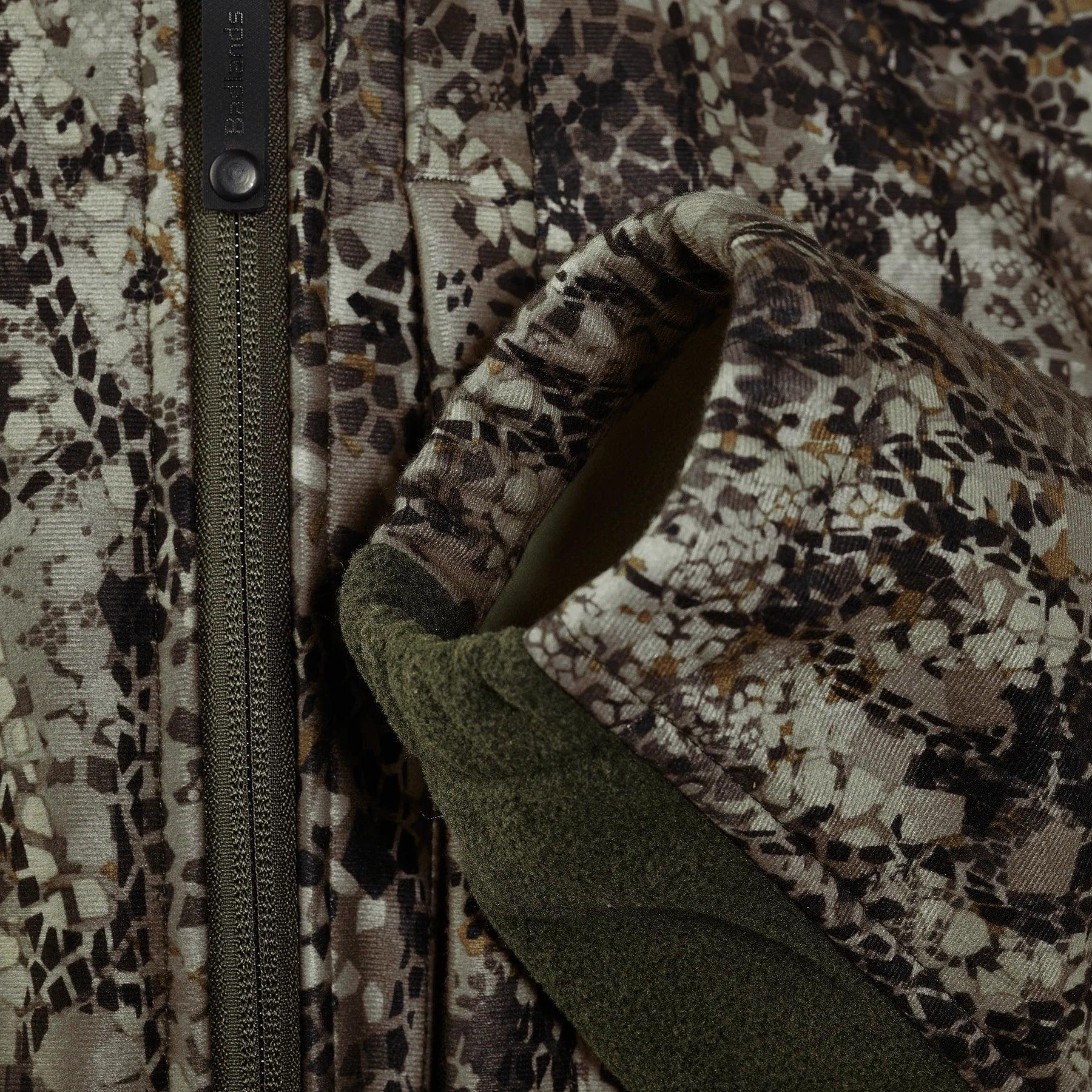 Close-up of camouflage hunting jacket with zipper and fleece-lined cuff detail
