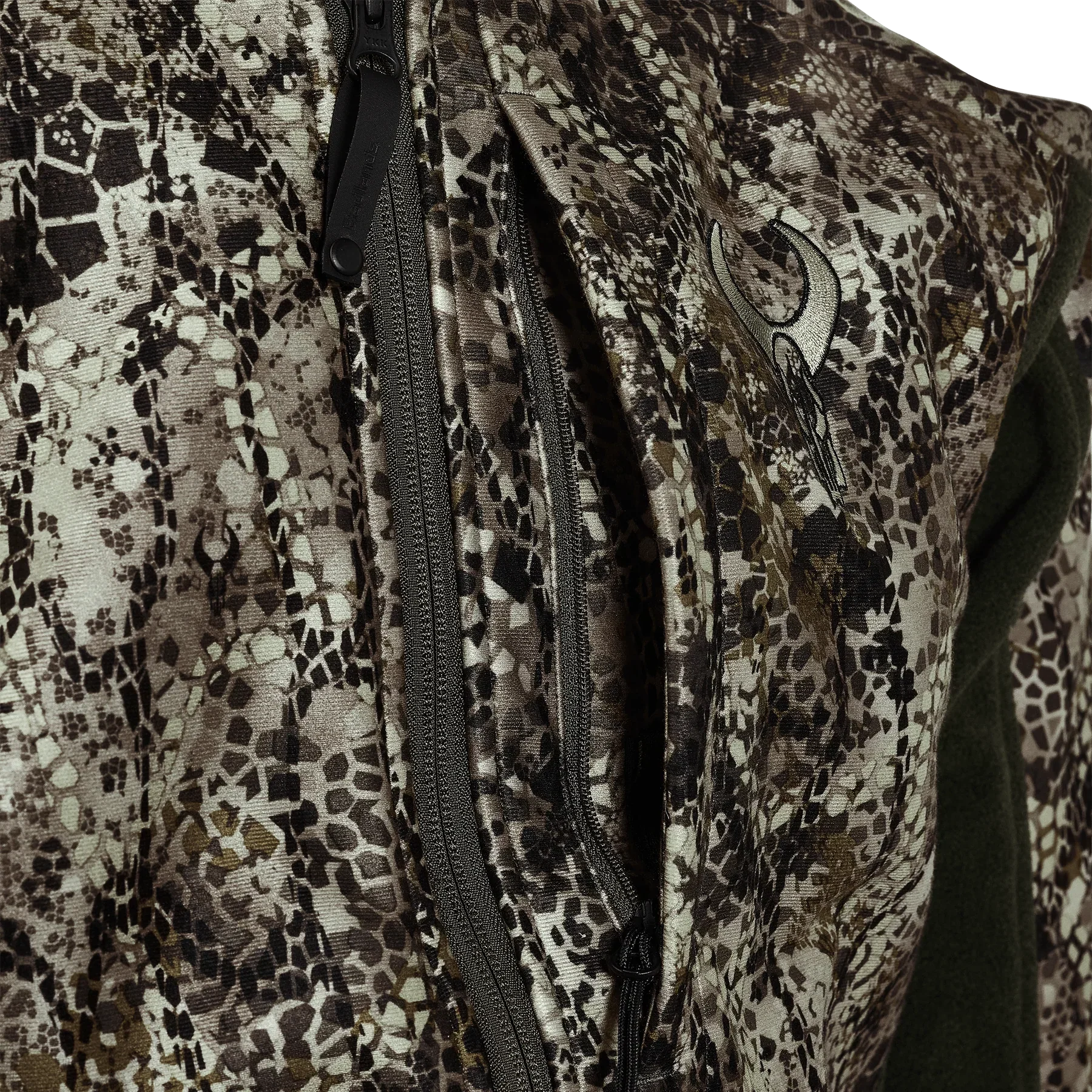 Close-up of camouflage hunting jacket with zippered pockets and embroidered logo