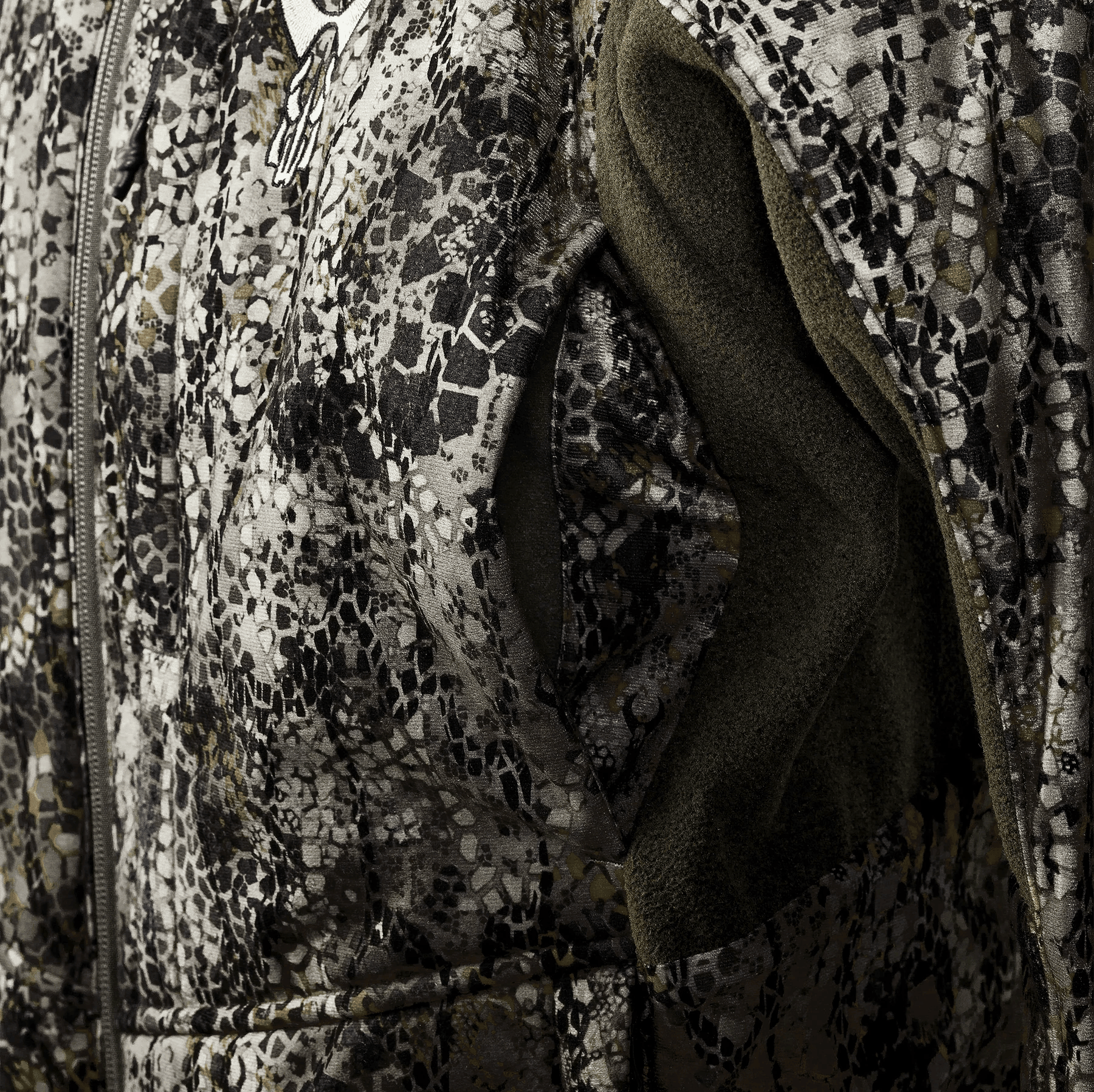 Close-up of camo patterned jacket with mesh inner lining and full zipper