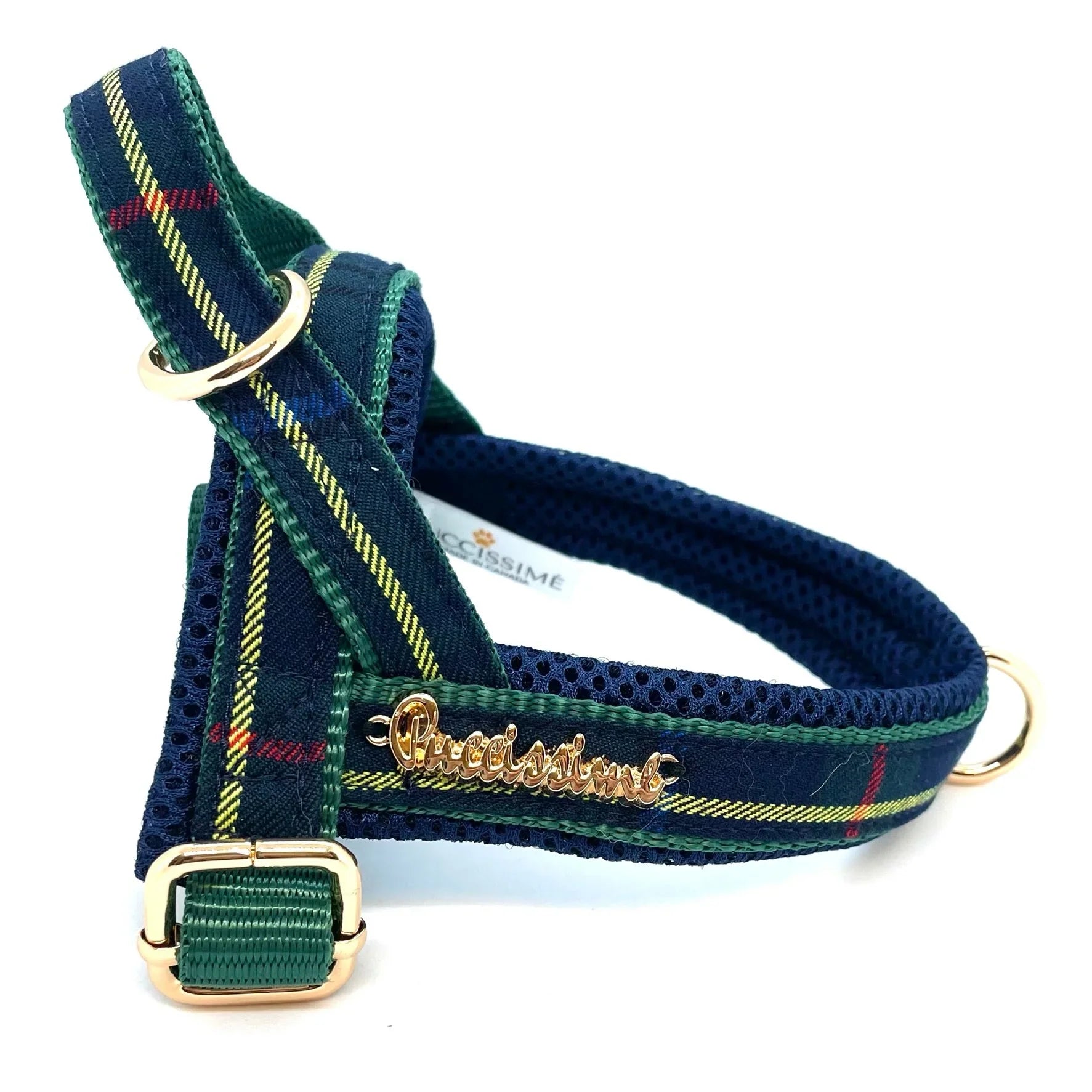 Green plaid dog harness with gold hardware and mesh lining on a white background