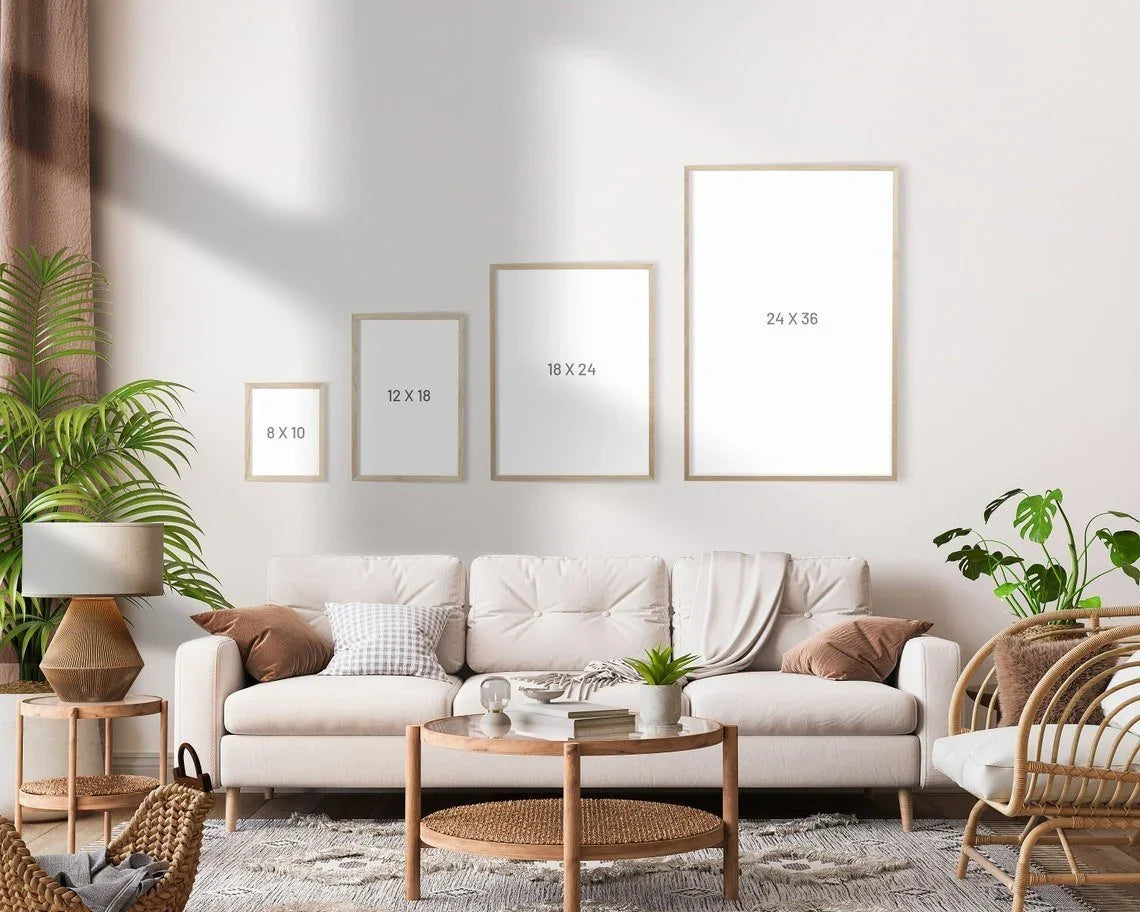 Modern living room with beige sofa, indoor plants, and four blank picture frames on the wall