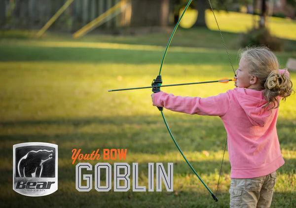 Child shooting Bear Archery Goblin youth bow outdoors, marketing banner in grassy park