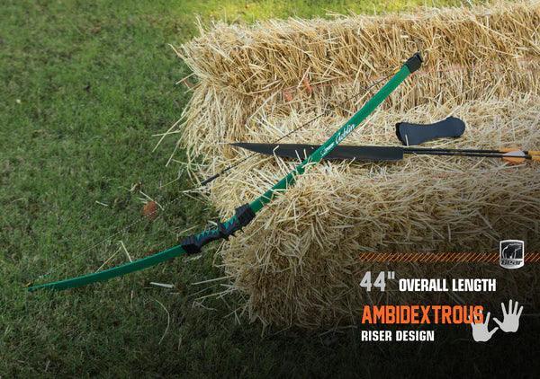 Bear Archery Goblin youth bow with arrows on hay bale outdoors, green riser, 44 inch ambidextrous design