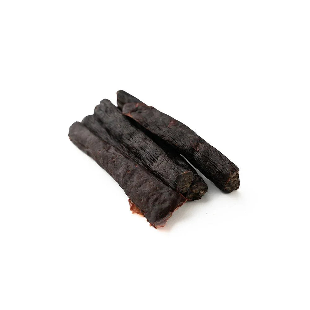Beef tripe sticks dog treats on white background, natural pet chews