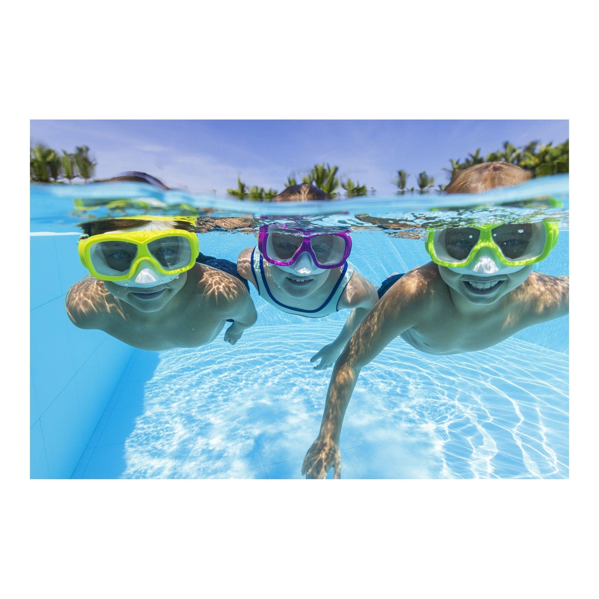 Three kids swimming underwater in a pool wearing colorful snorkel masks, sunny day