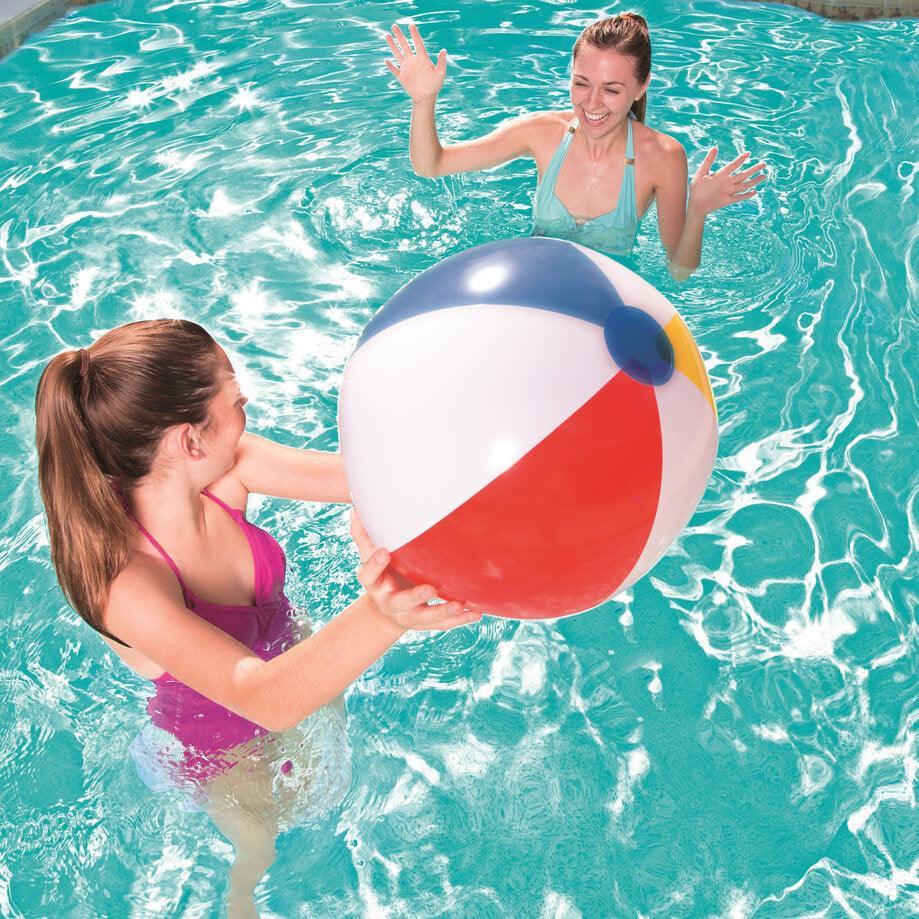 Two women playing with a colorful Bestway beach ball in a clear swimming pool