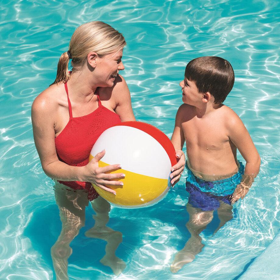 Woman and boy playing with Bestway 20 inch beach ball in a swimming pool