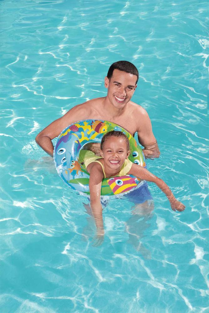 Child using Sweet Creature swim tube in pool with adult, colorful inflatable 56cm