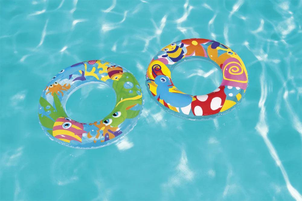 Two colorful animal-themed swim tubes floating in a clear blue swimming pool