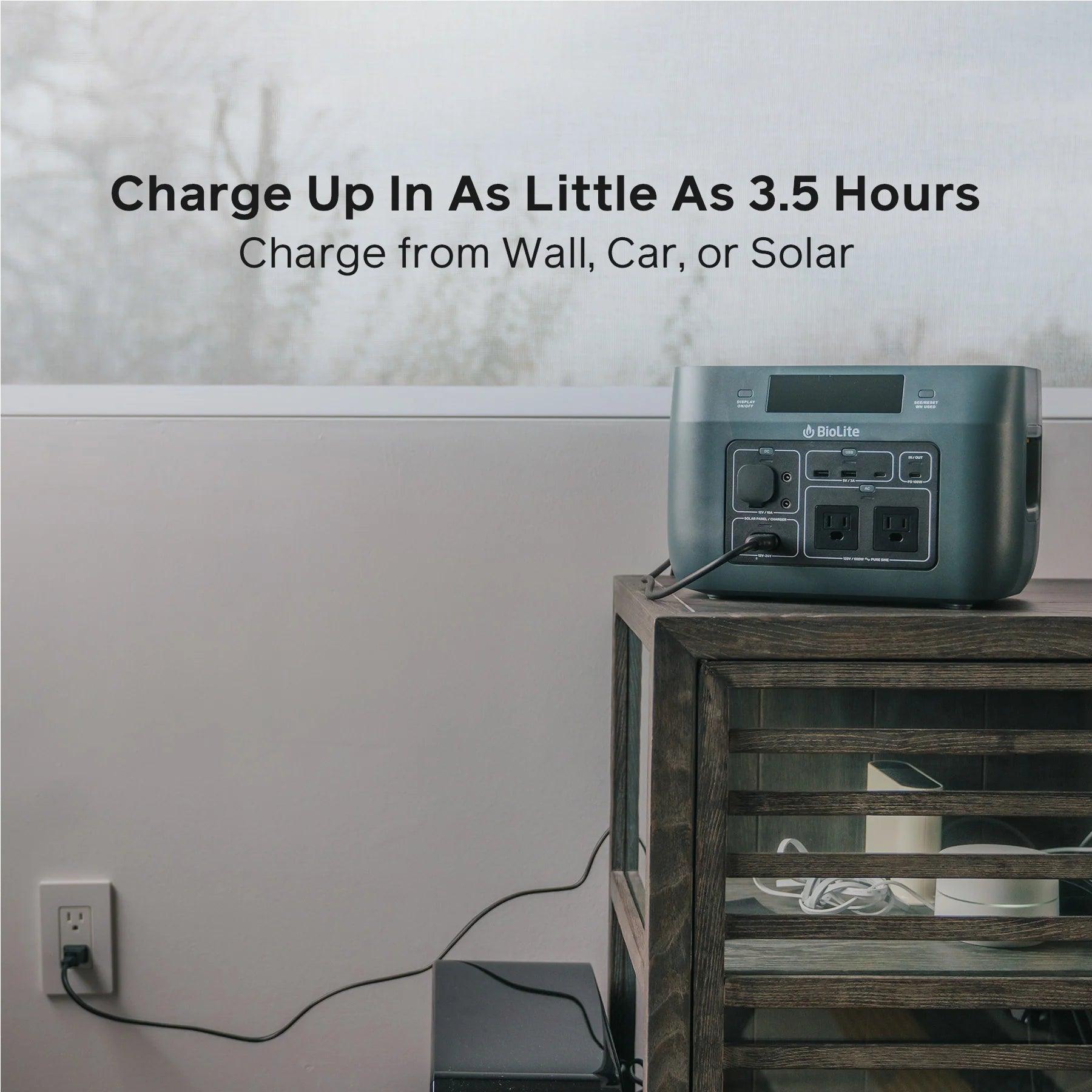 BioLite BaseCharge 600 portable power station charging on wooden table indoors