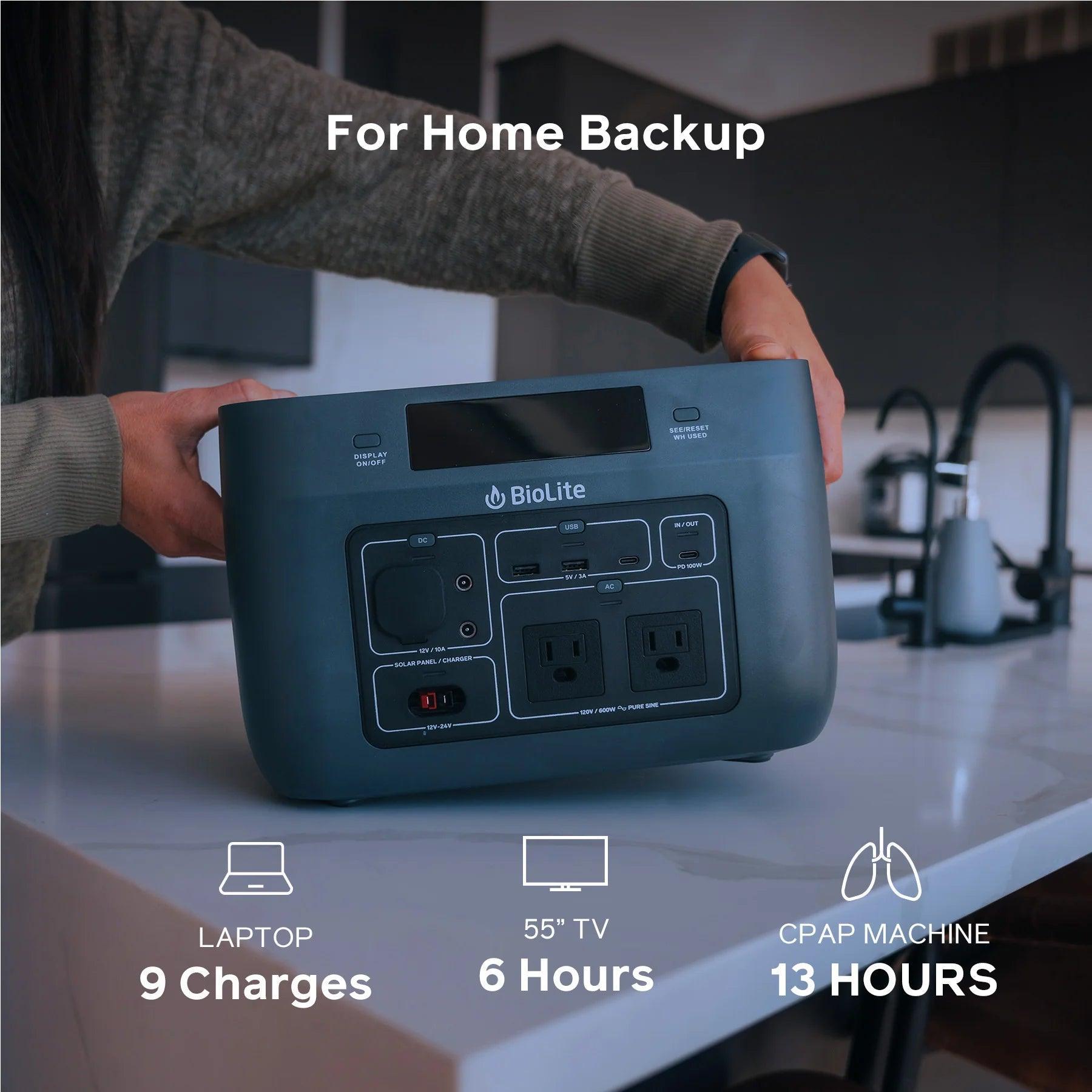 Person holding BioLite BaseCharge 600 portable power station on kitchen counter, home backup