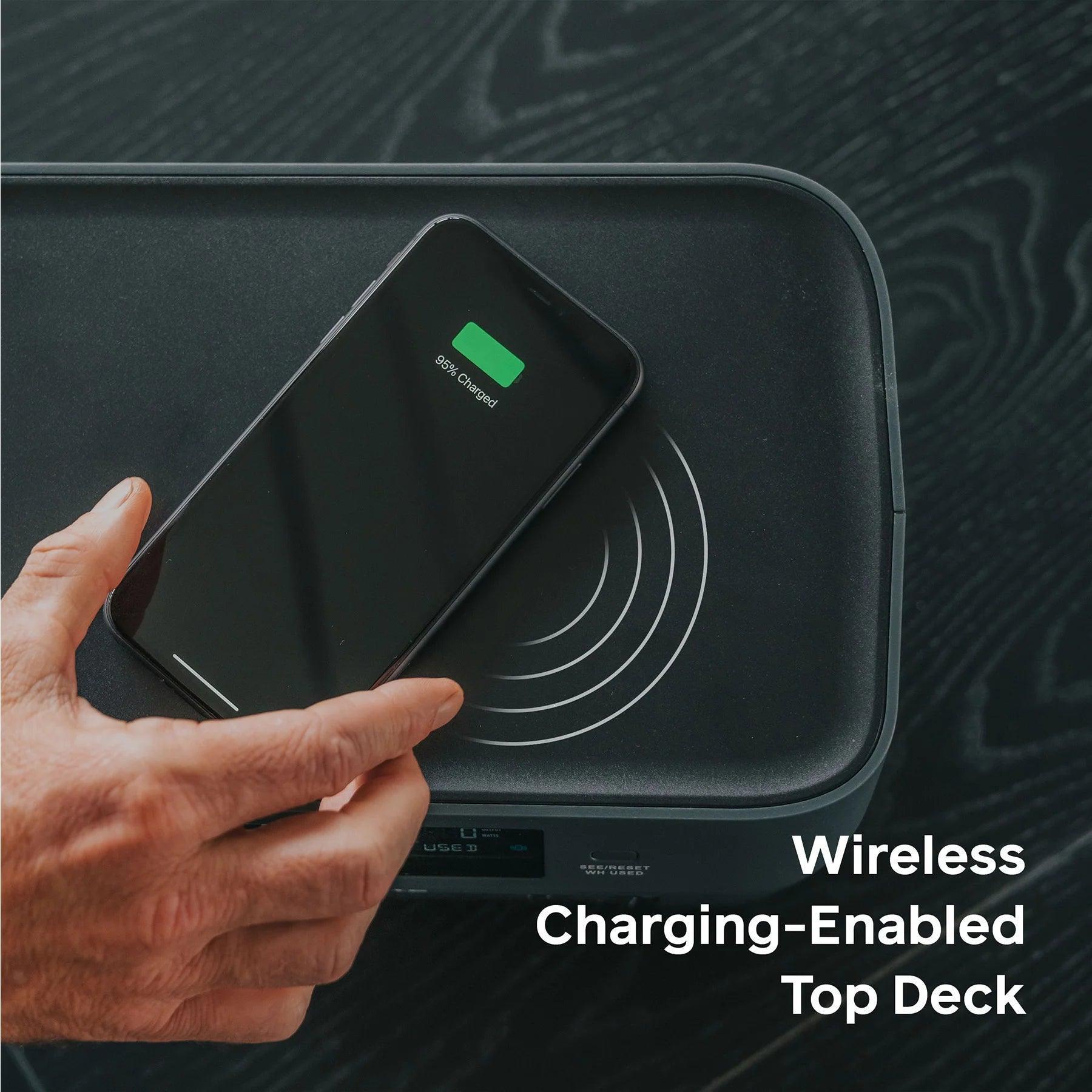 Hand charging smartphone wirelessly on BioLite BaseCharge 600 portable power station