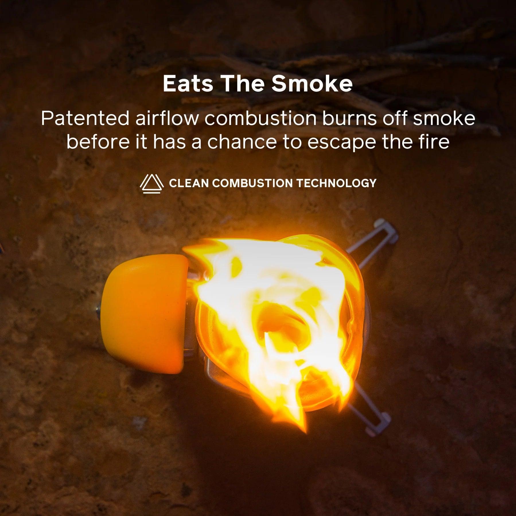 BioLite CampStove 2 burning with clean flame on outdoor ground, showing smoke-reducing tech.