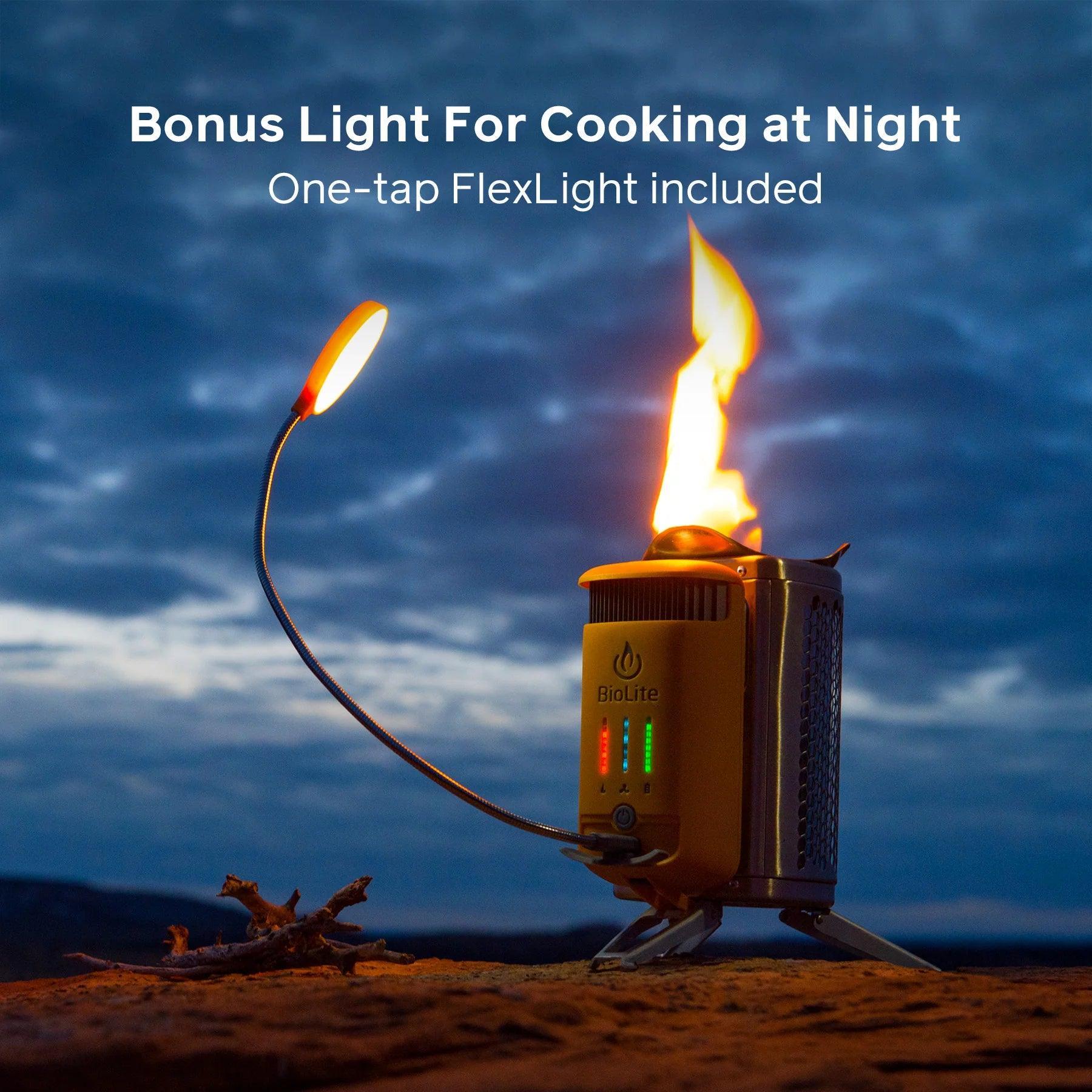 BioLite CampStove 2 with FlexLight on at night outdoors, fire burning, cloudy sky background