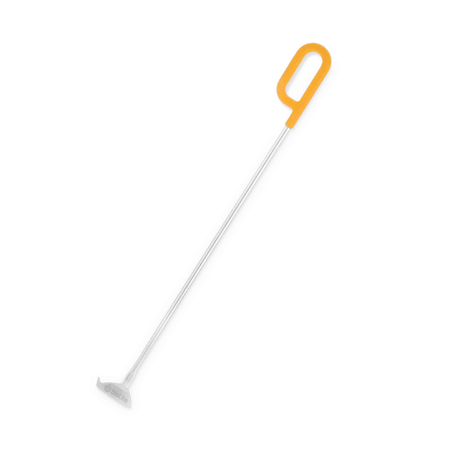 BioLite fire pit fire poker with orange handle on a gray background