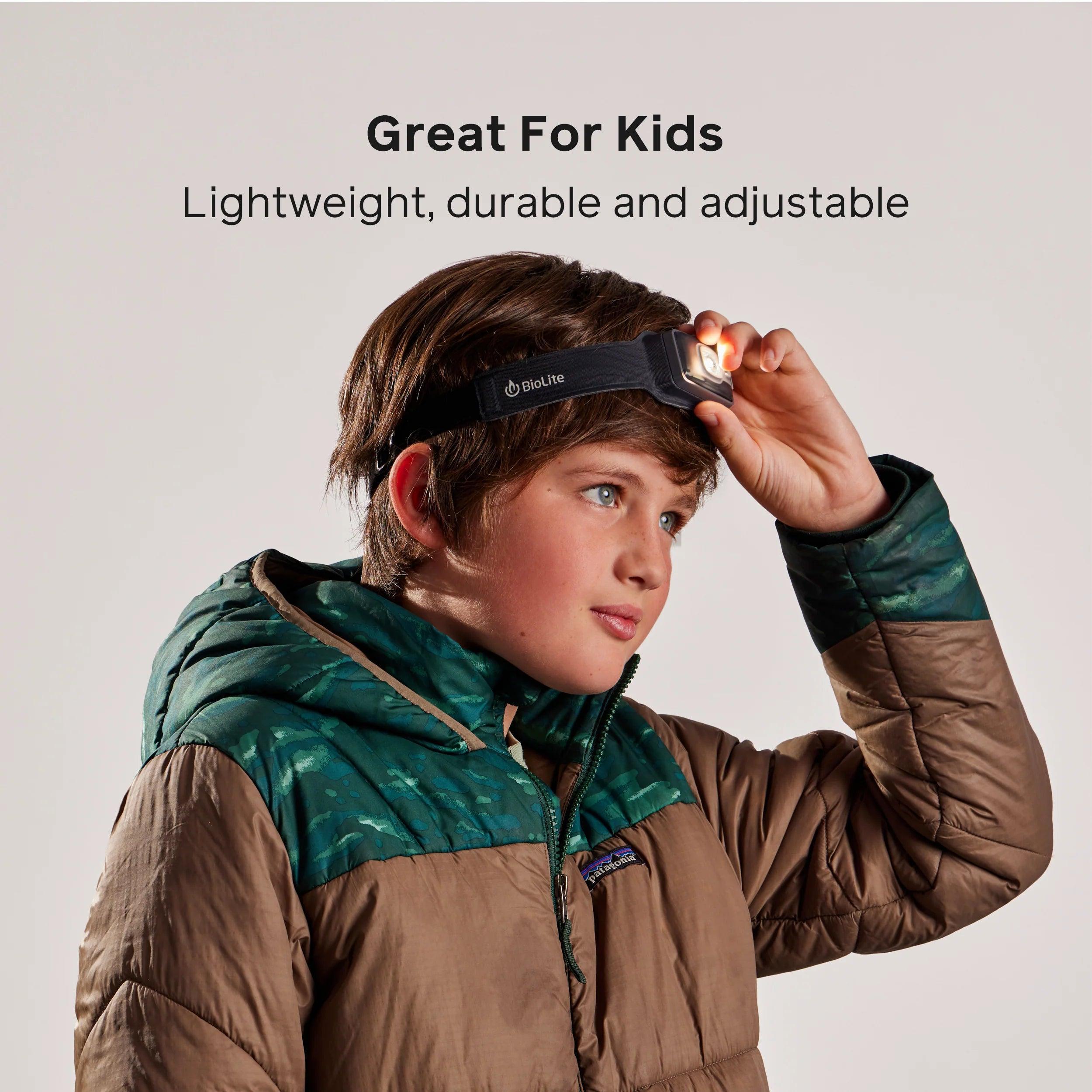 Boy wearing Biolite headlamp and brown puffer jacket, product for kids outdoor gear