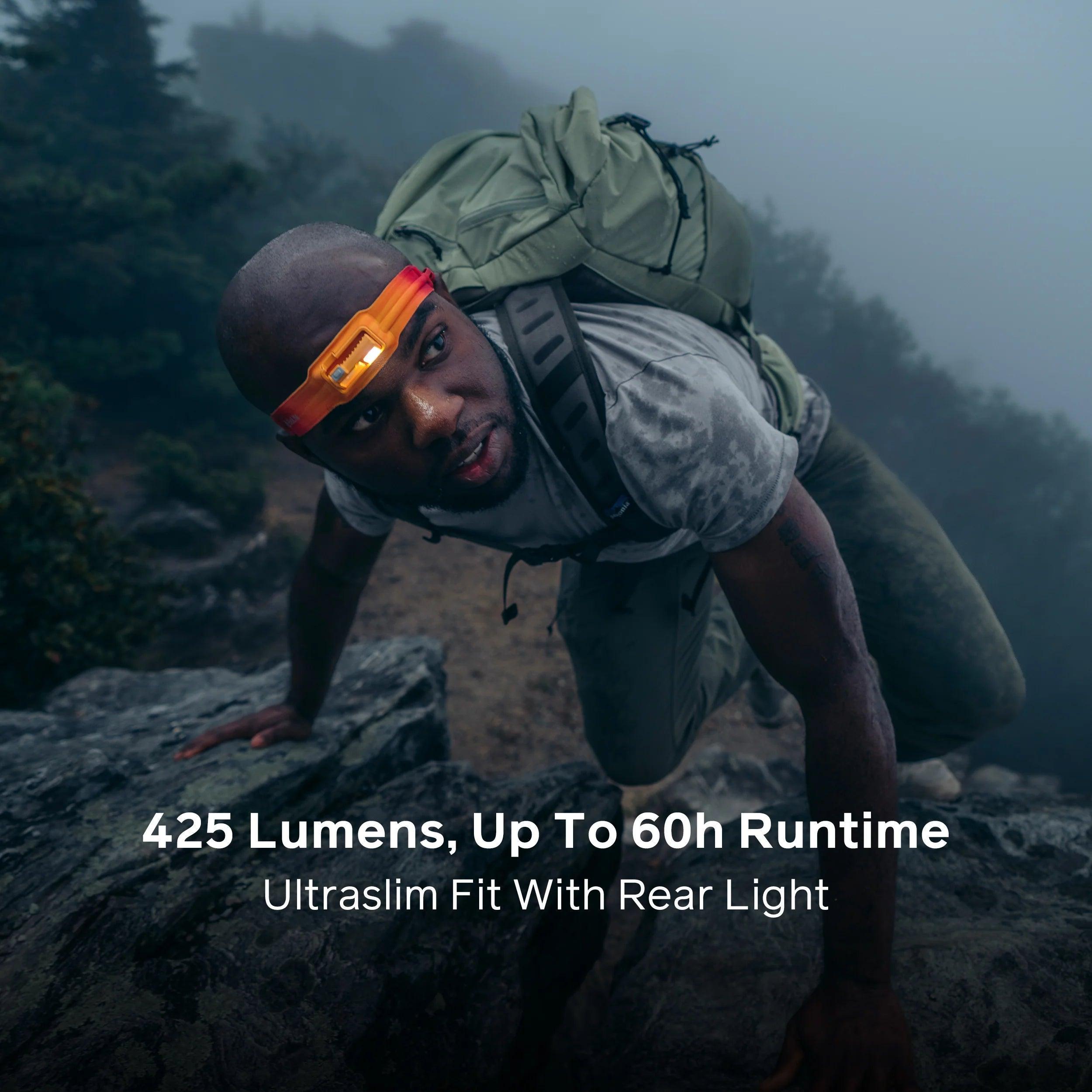 Man hiking in foggy mountains wearing Biolite Headlamp 425, carrying a backpack