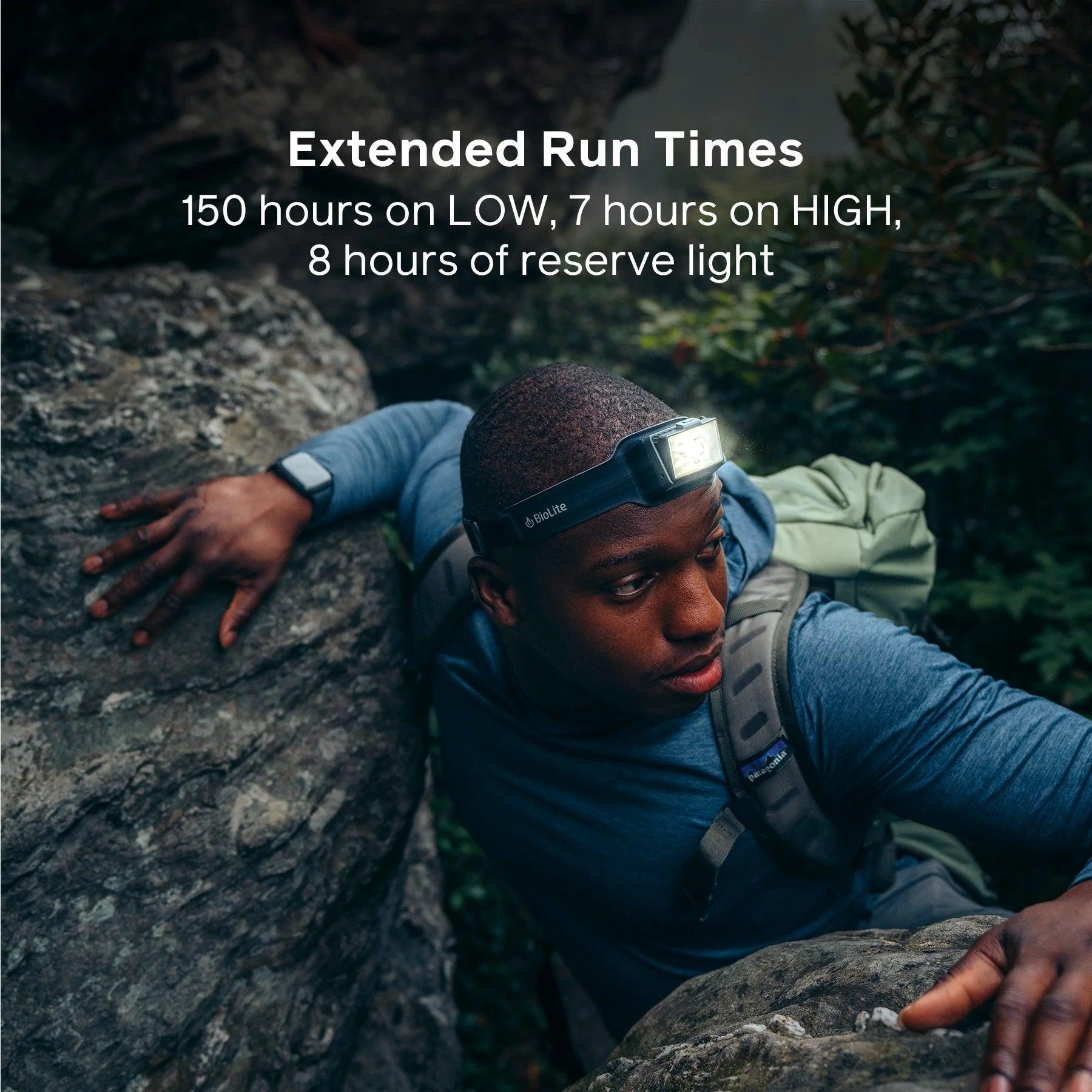 Man wearing BioLite Headlamp 800 Pro climbing rocks outdoors with backpack