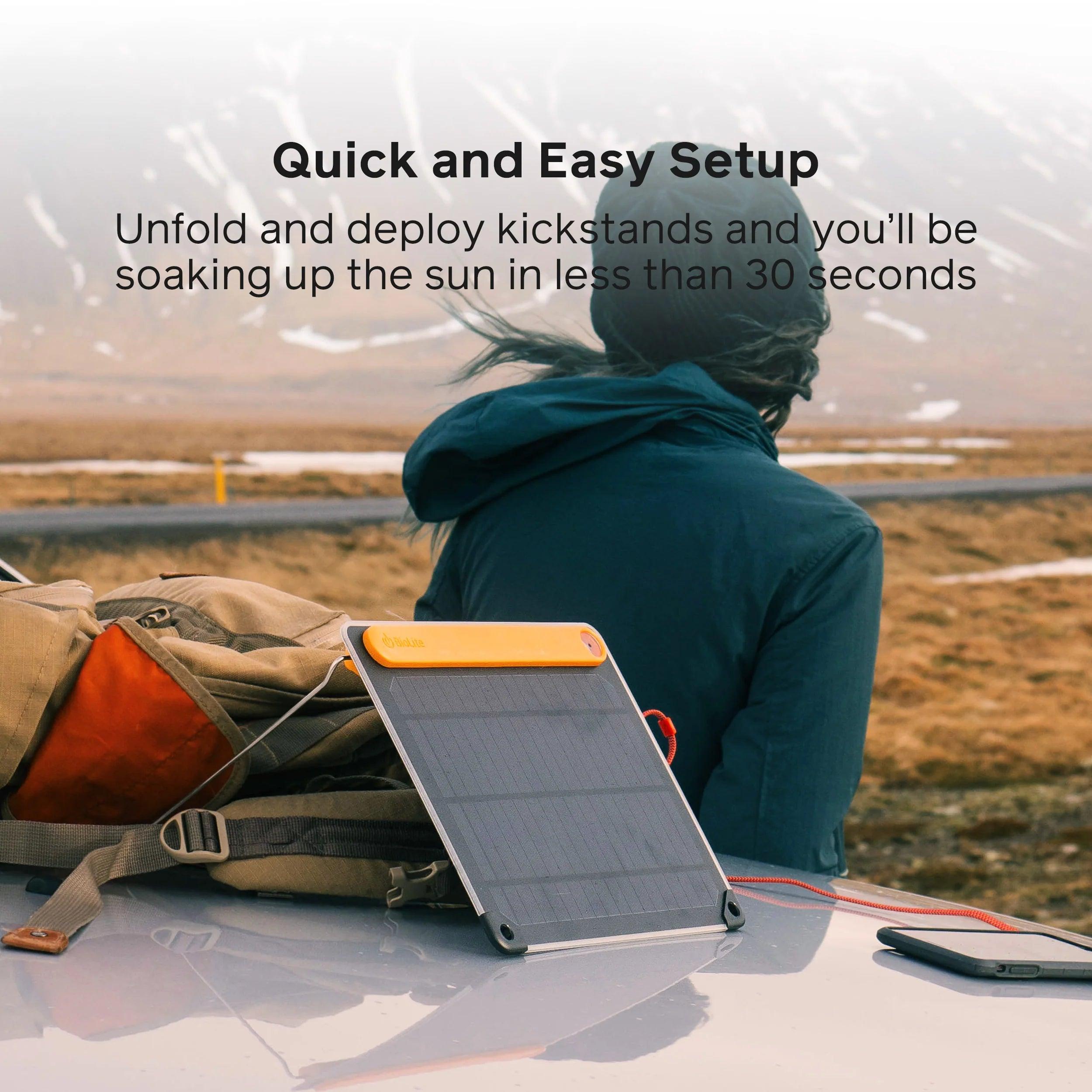 BioLite SolarPanel 5 on car with backpack, outdoor setup in scenic, mountainous landscape