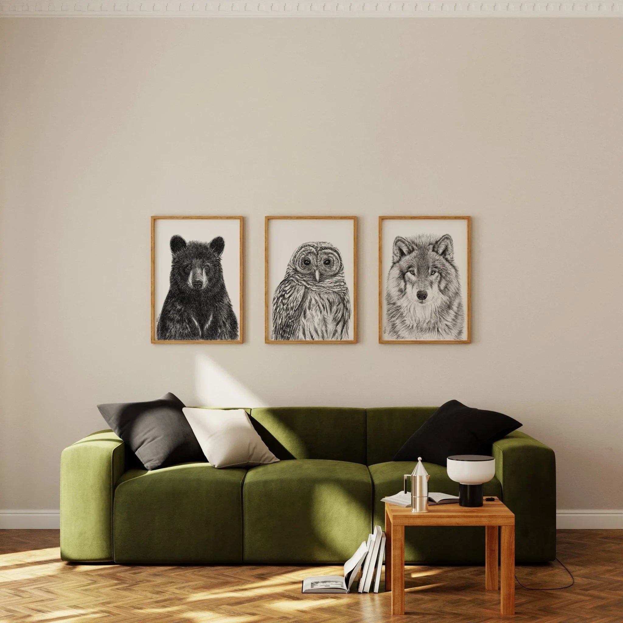 Black bear portrait drawing in wooden frame hanging on a beige living room wall.