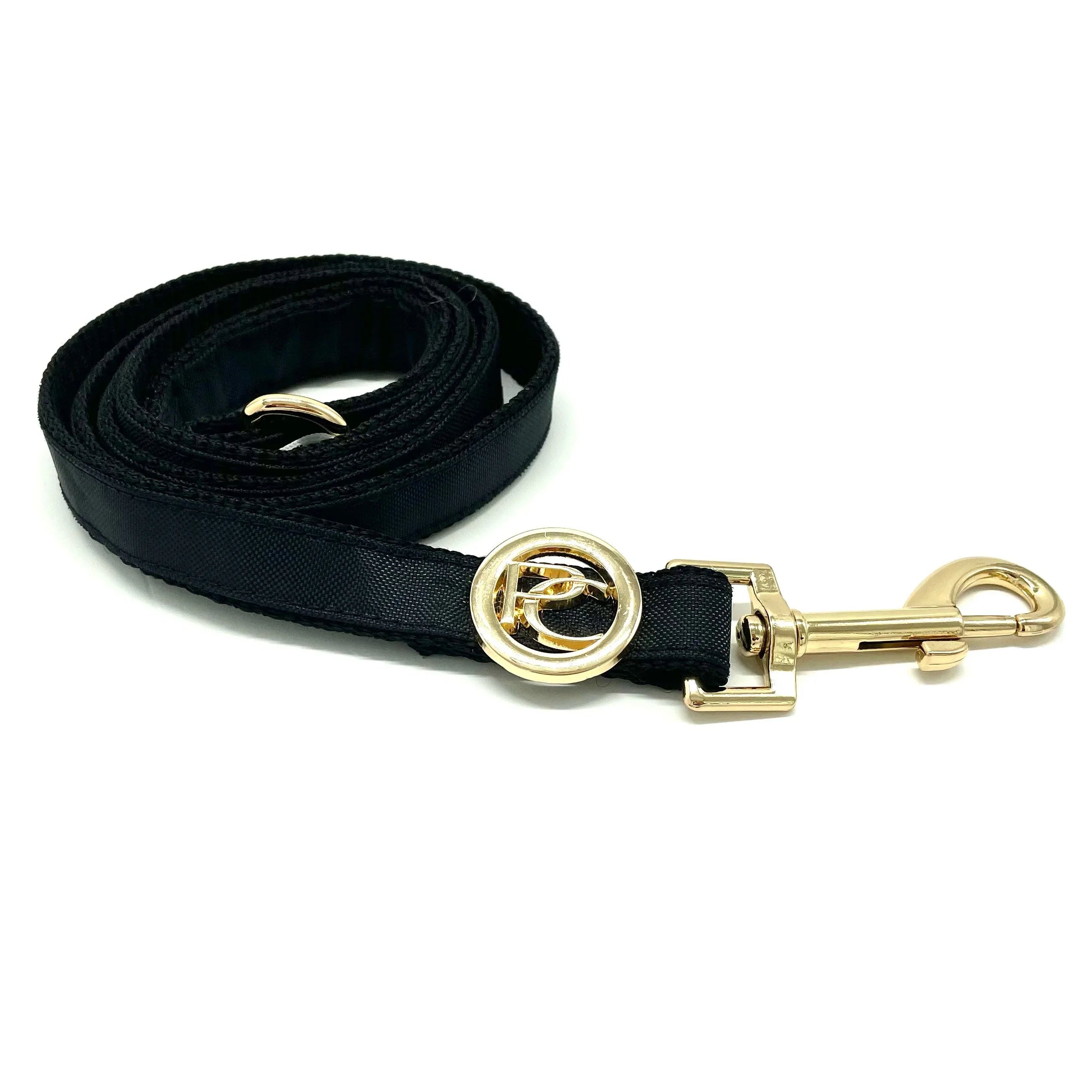 Black dog leash with gold clasp and circular designer logo on white background